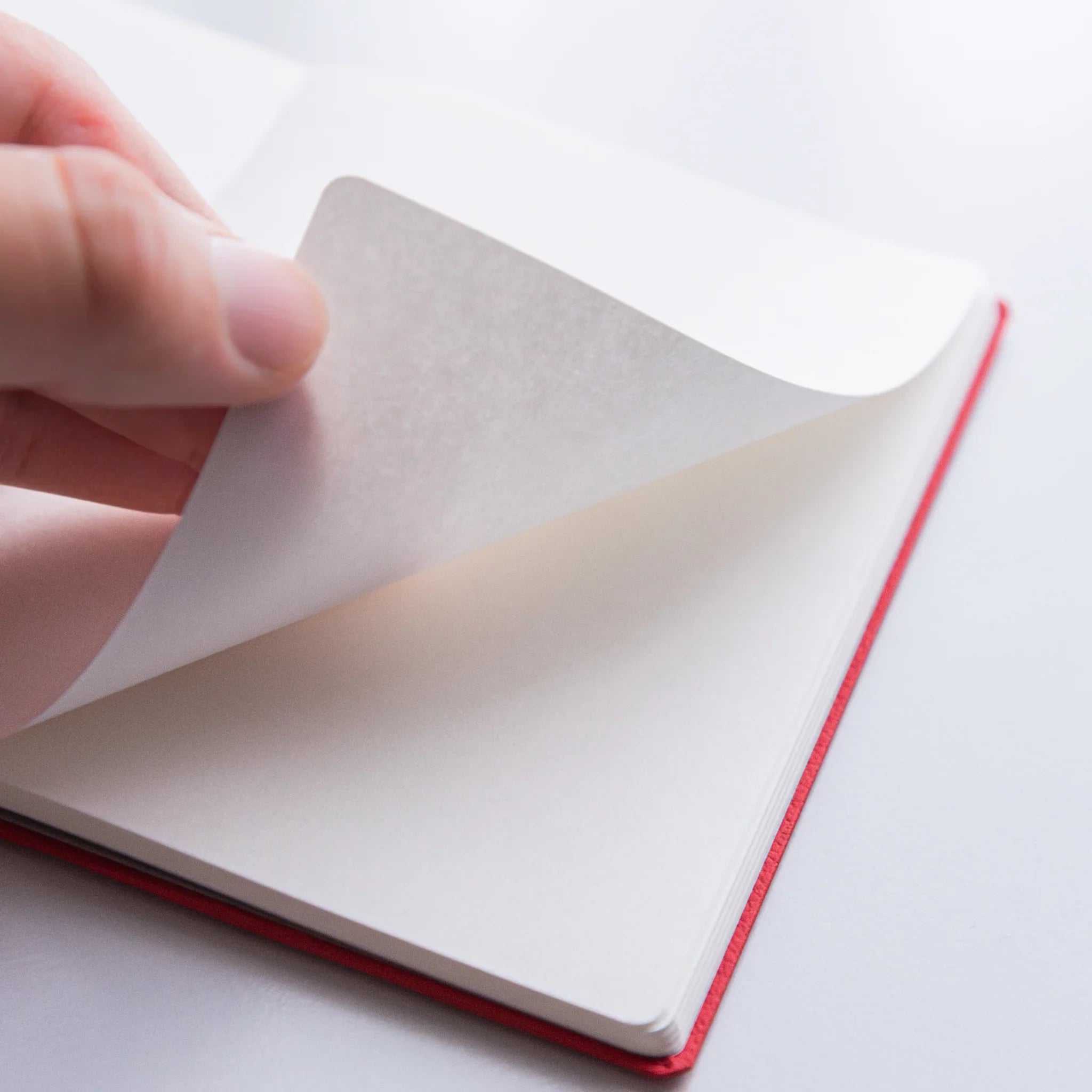 Turning pages of Dressco Bank Ledger Paper Japanese Notebook in Red.