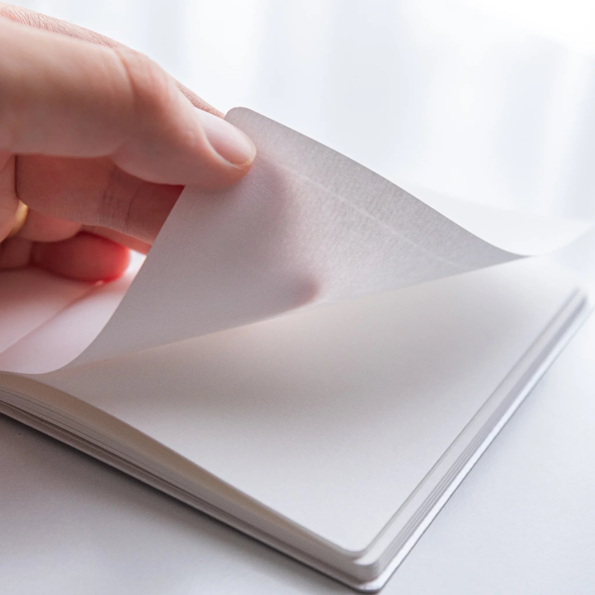 Turning pages of Dressco Bank Ledger Paper Japanese Notebook in Champagne Gold showing texture.