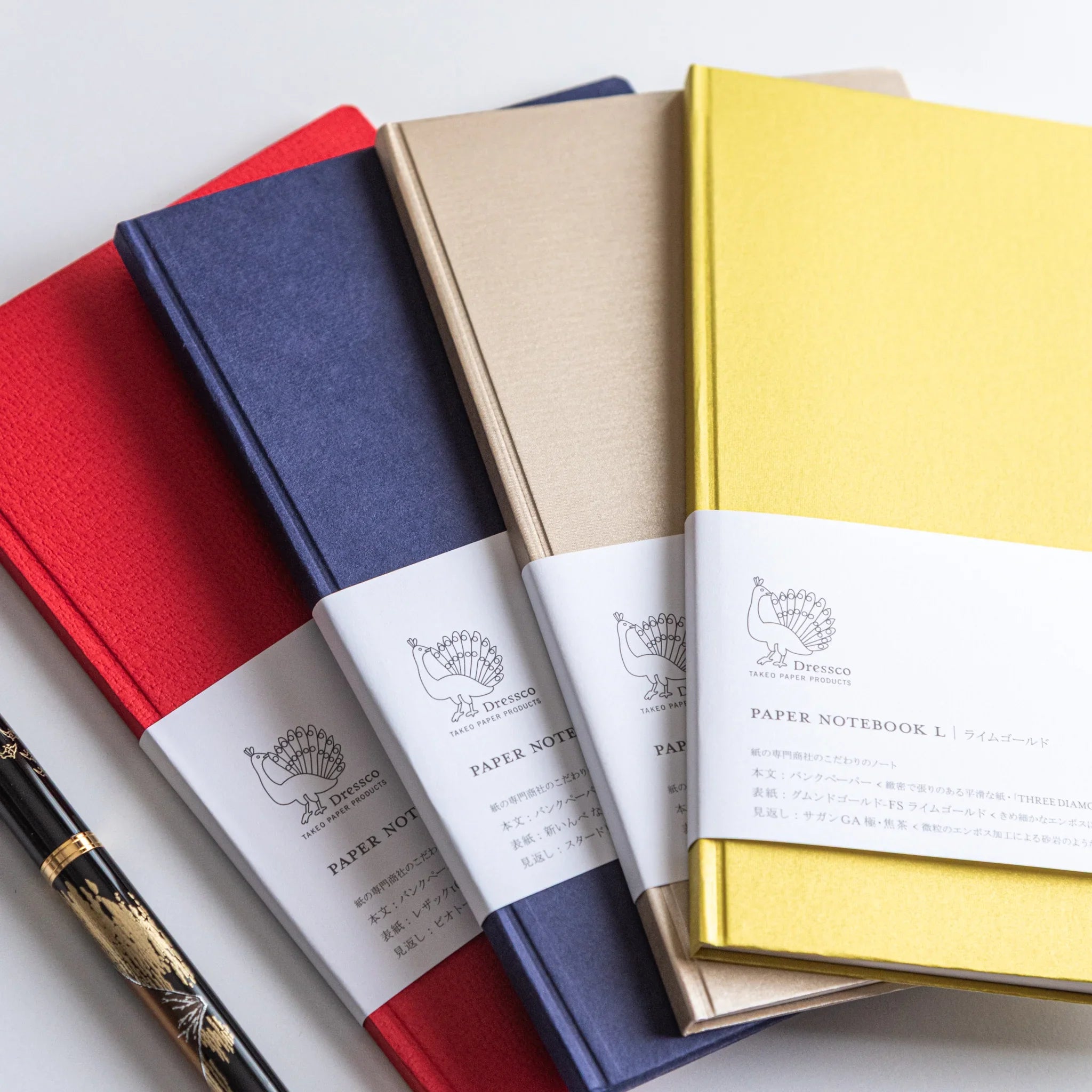 Set of four Dressco Bank Ledger Paper Japanese Notebooks in assorted colors with soft light.