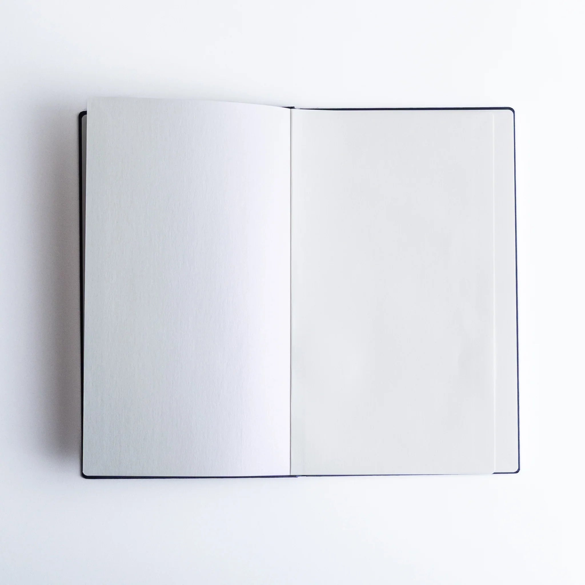 Open Dressco Bank Ledger Paper Japanese Notebook in Navy with blank pages.