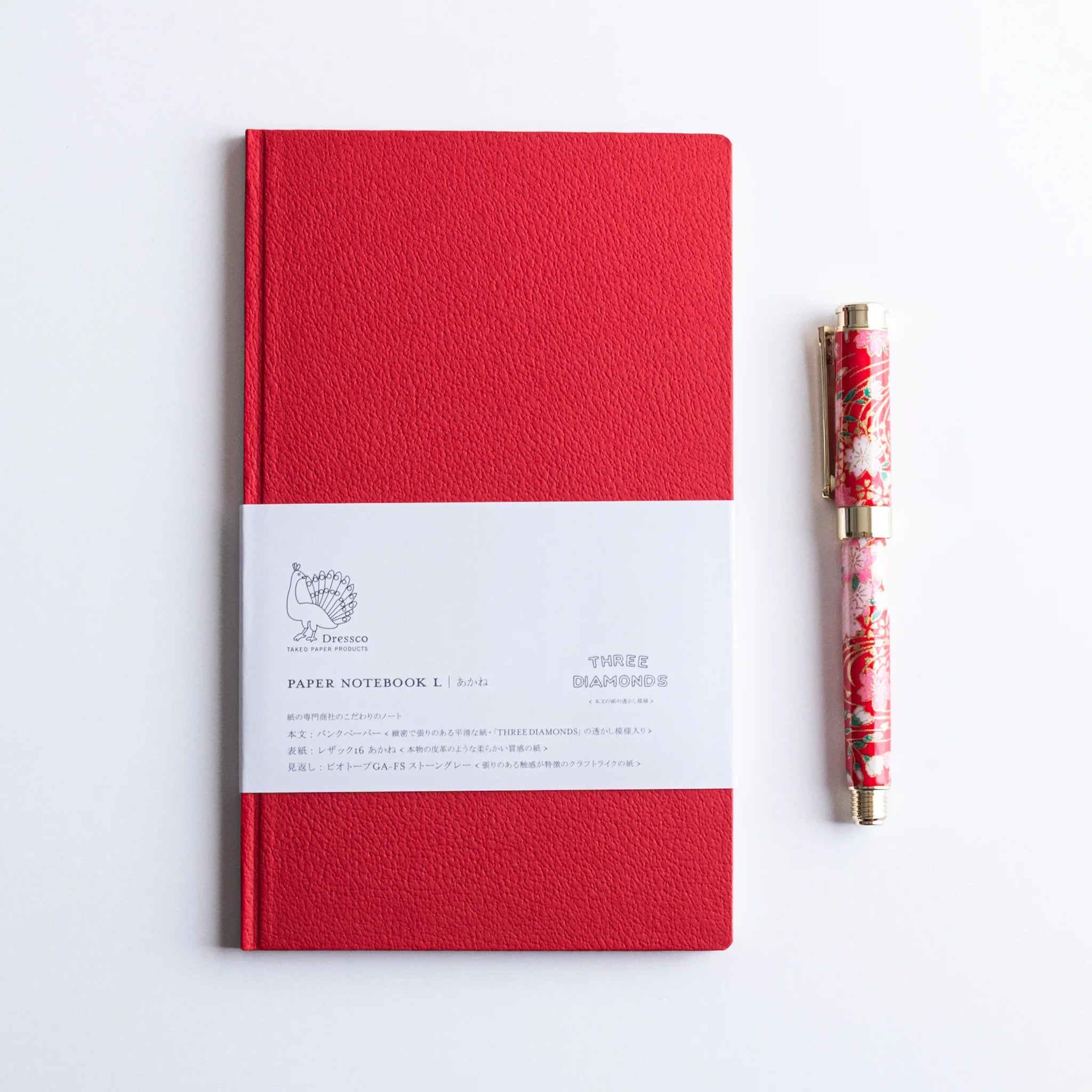Red Dressco Japanese Notebook with lacquered Japanese Fountain Pen beside it.