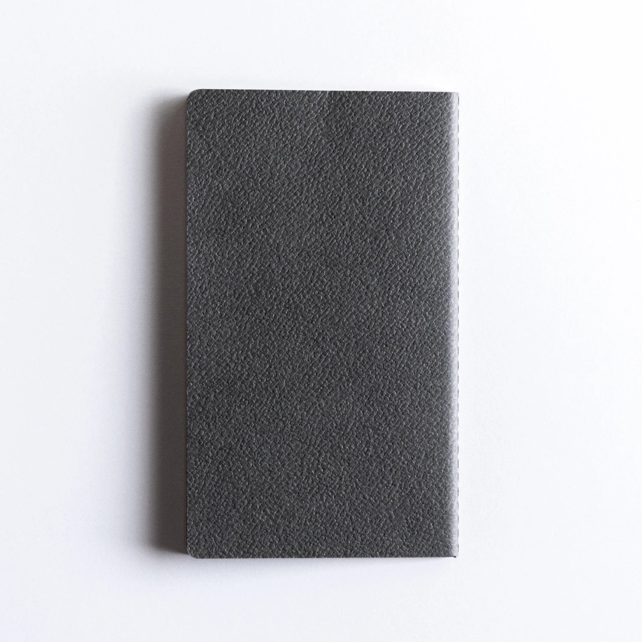Minimalist flat lay of Dressco Bank Ledger Paper Stitched Japanese Notebook, Gray cover.
