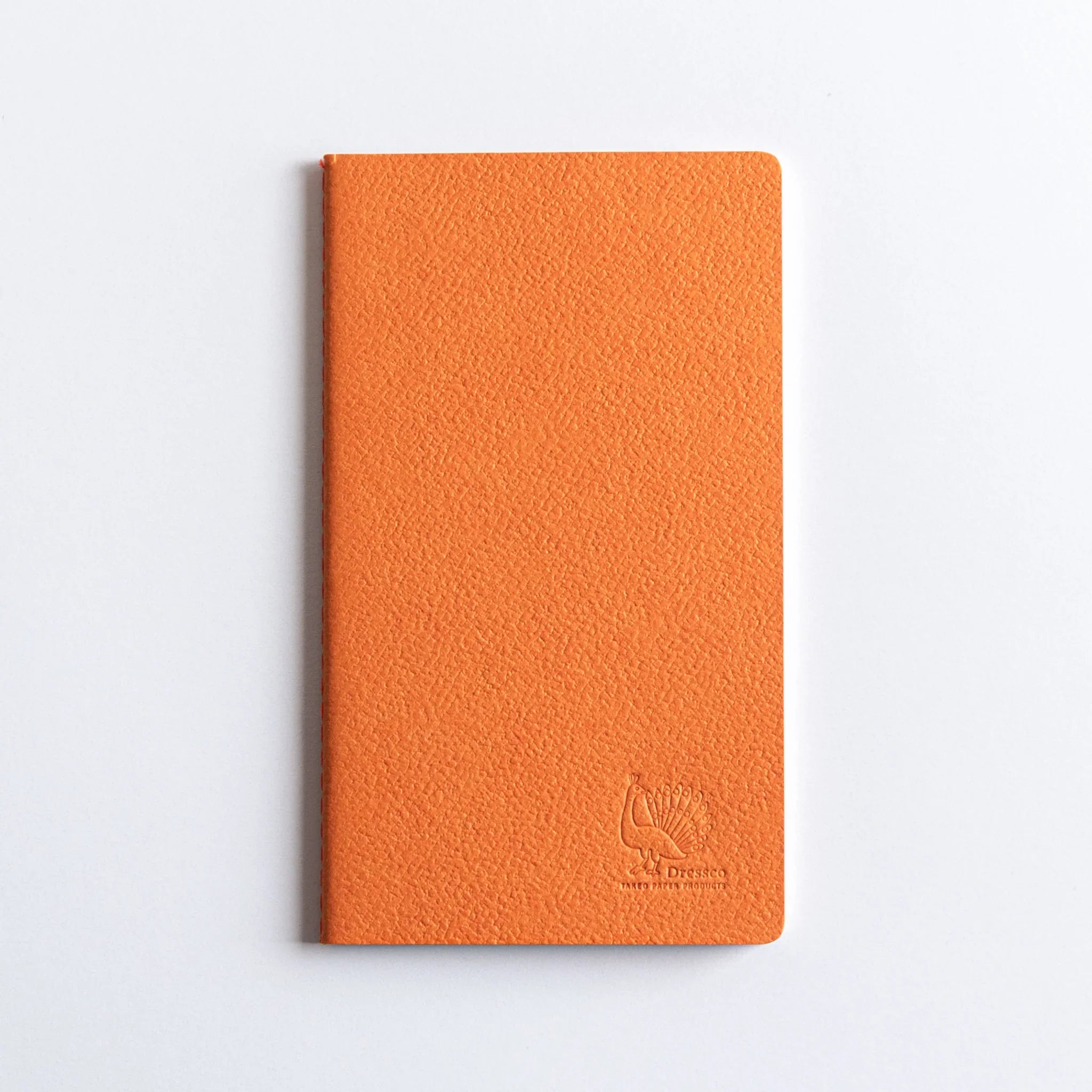Close-up of Dressco logo embossed on the orange leather-textured cover.