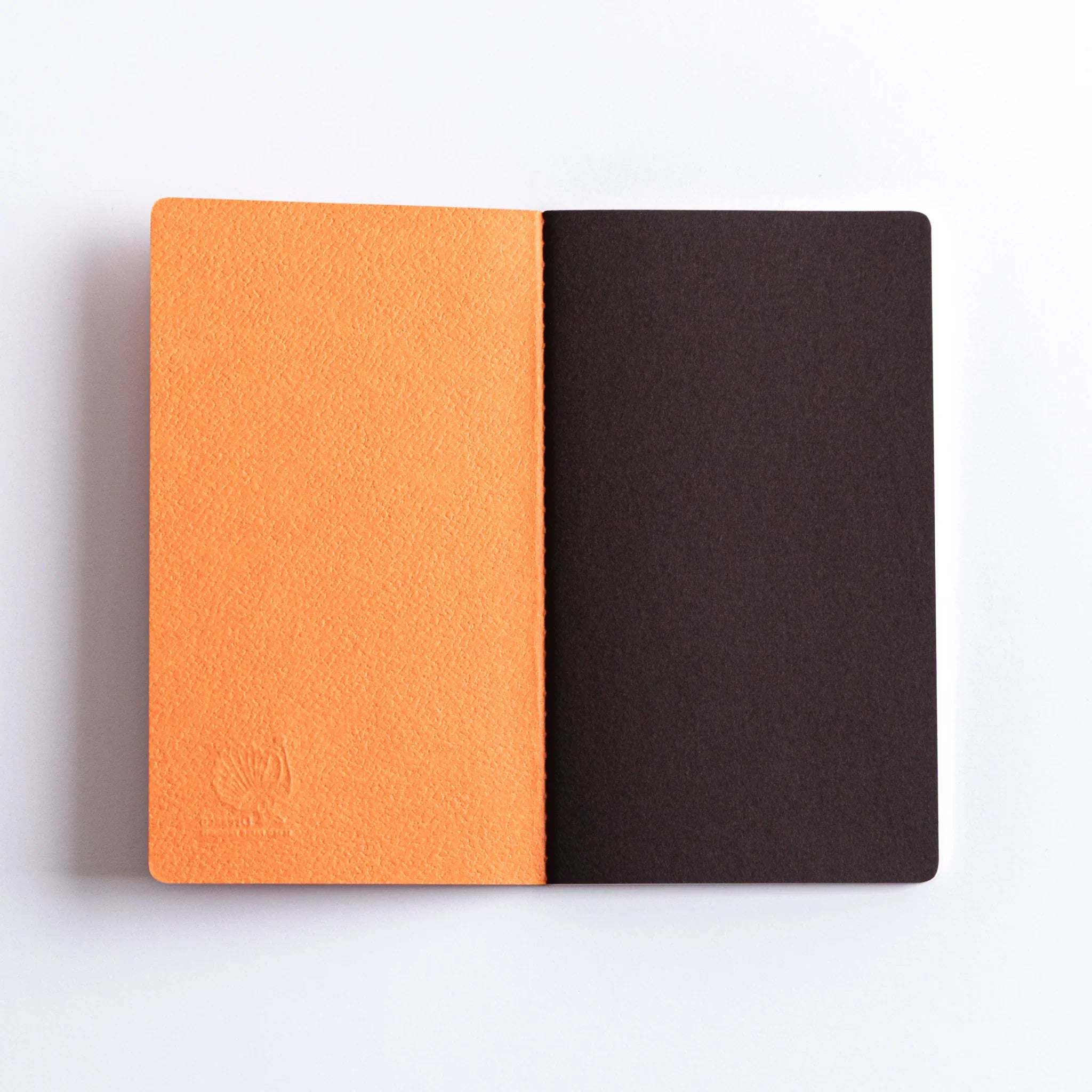 Inside cover of Dressco Bank Ledger Paper Stitched Japanese Notebook, Orange, with dark brown endpaper.