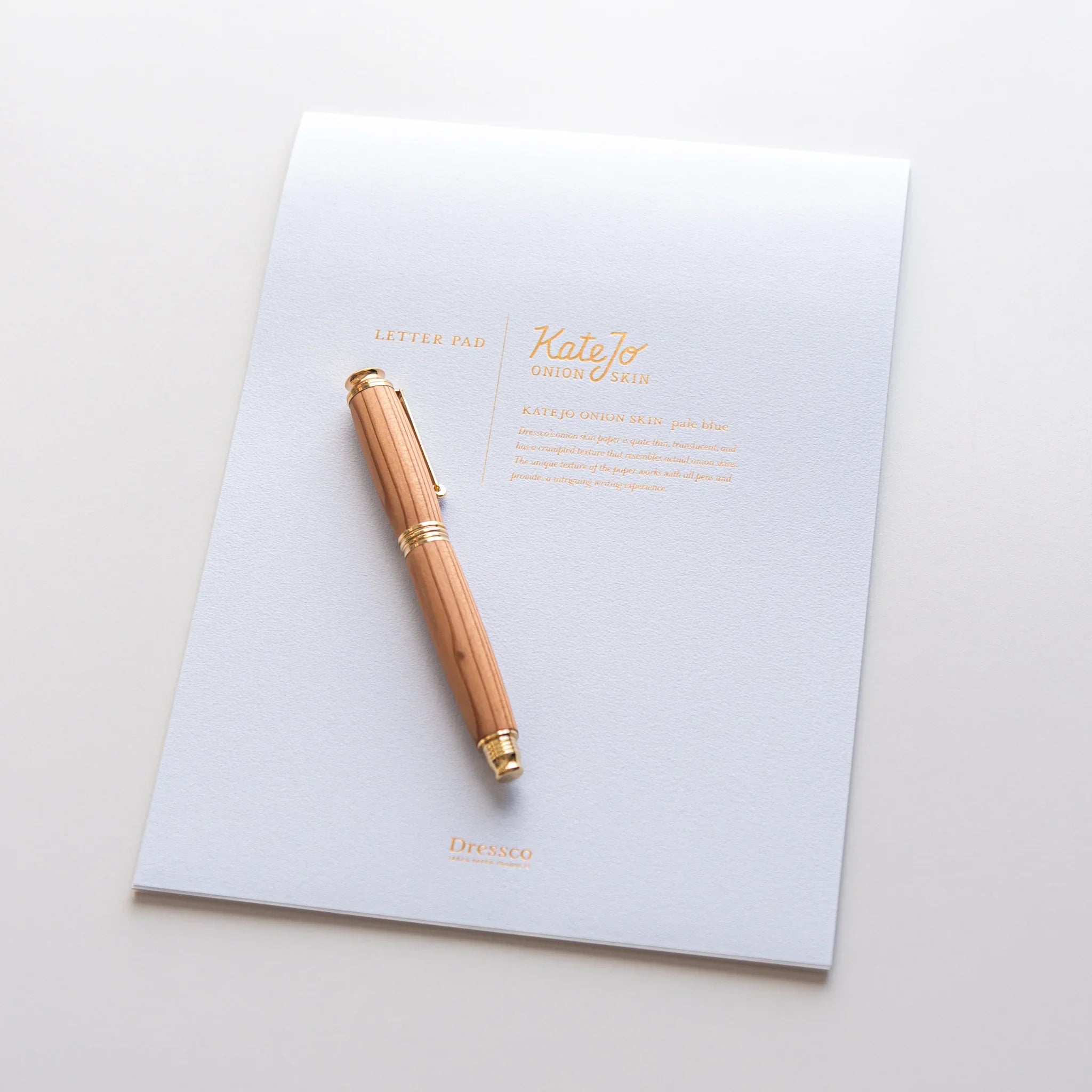 Dressco Blue Onion Skin Japanese Paper Writing Pad with wooden fountain pen placed on page.