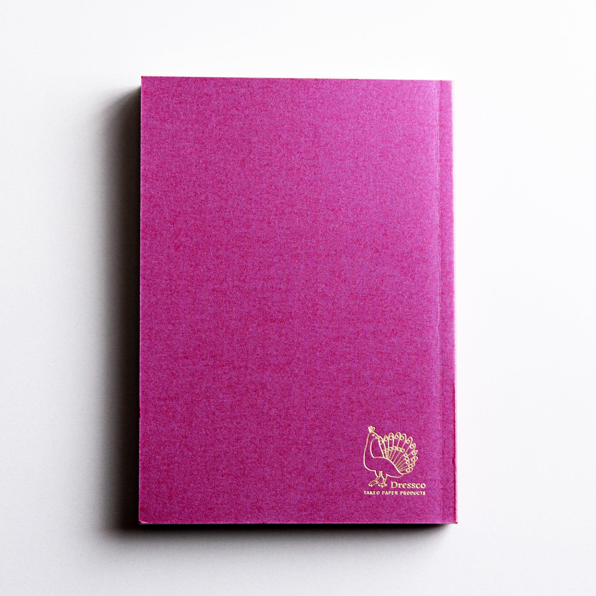 Back cover of Dressco Pink Onion Skin Japanese Notebook A6 featuring gold Dressco peacock logo.