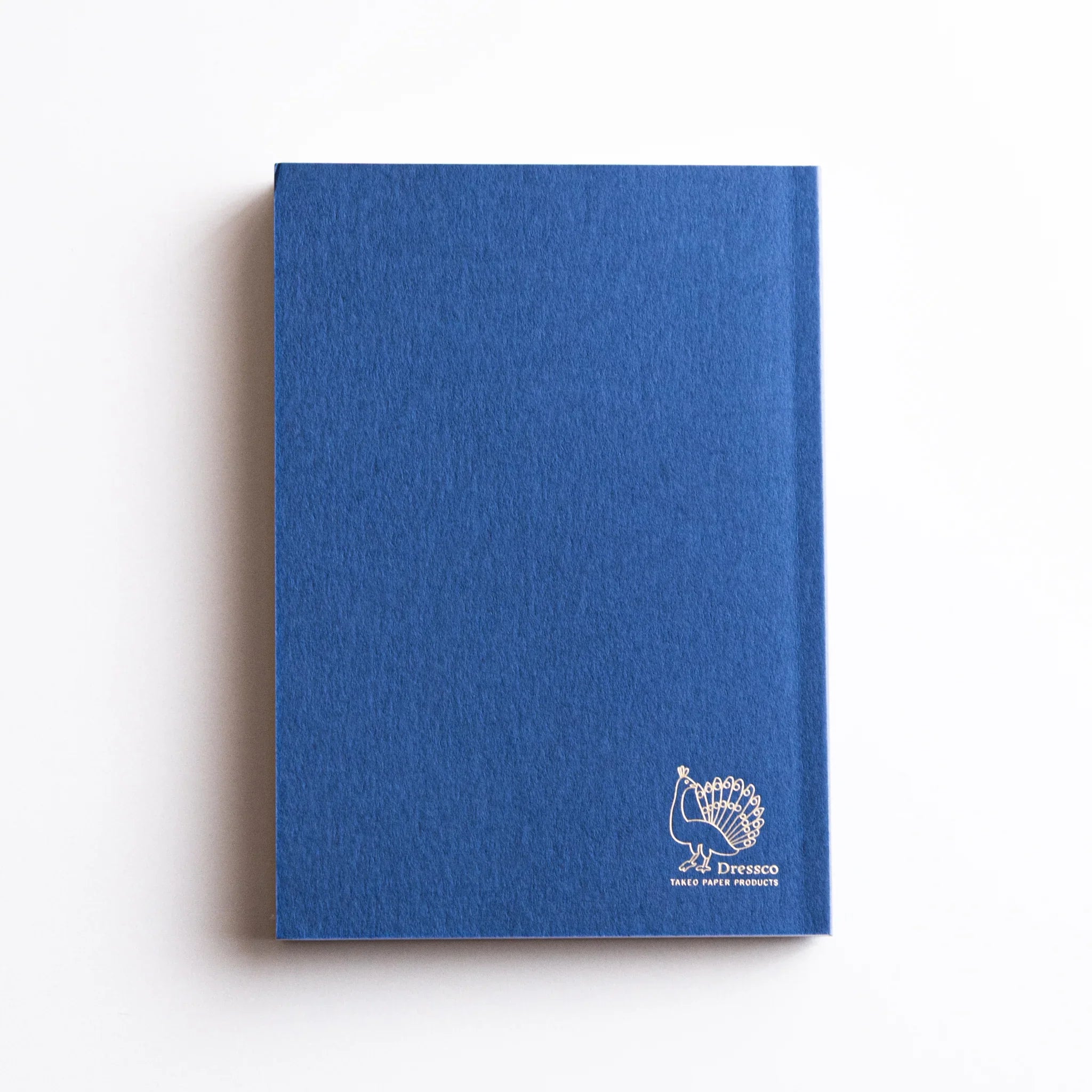 Dressco Blue Onion Skin Japanese Notebook A6 showing white peacock logo embossed on the back.