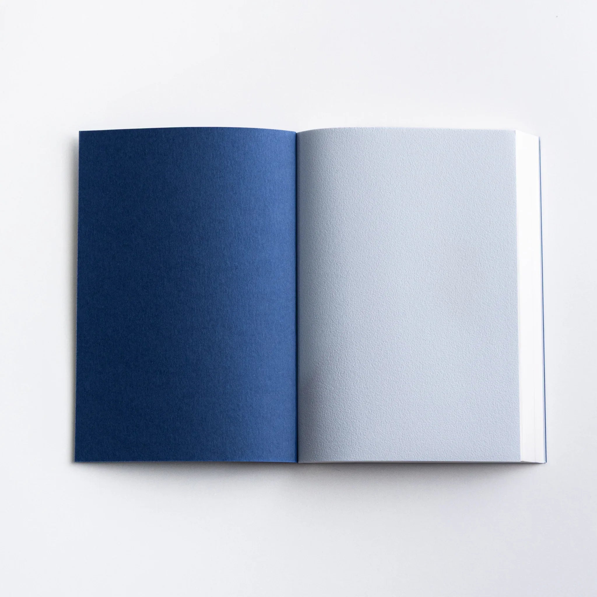 Inside cover of Dressco Blue Onion Skin Japanese Notebook A6 showing navy and gray endpapers.