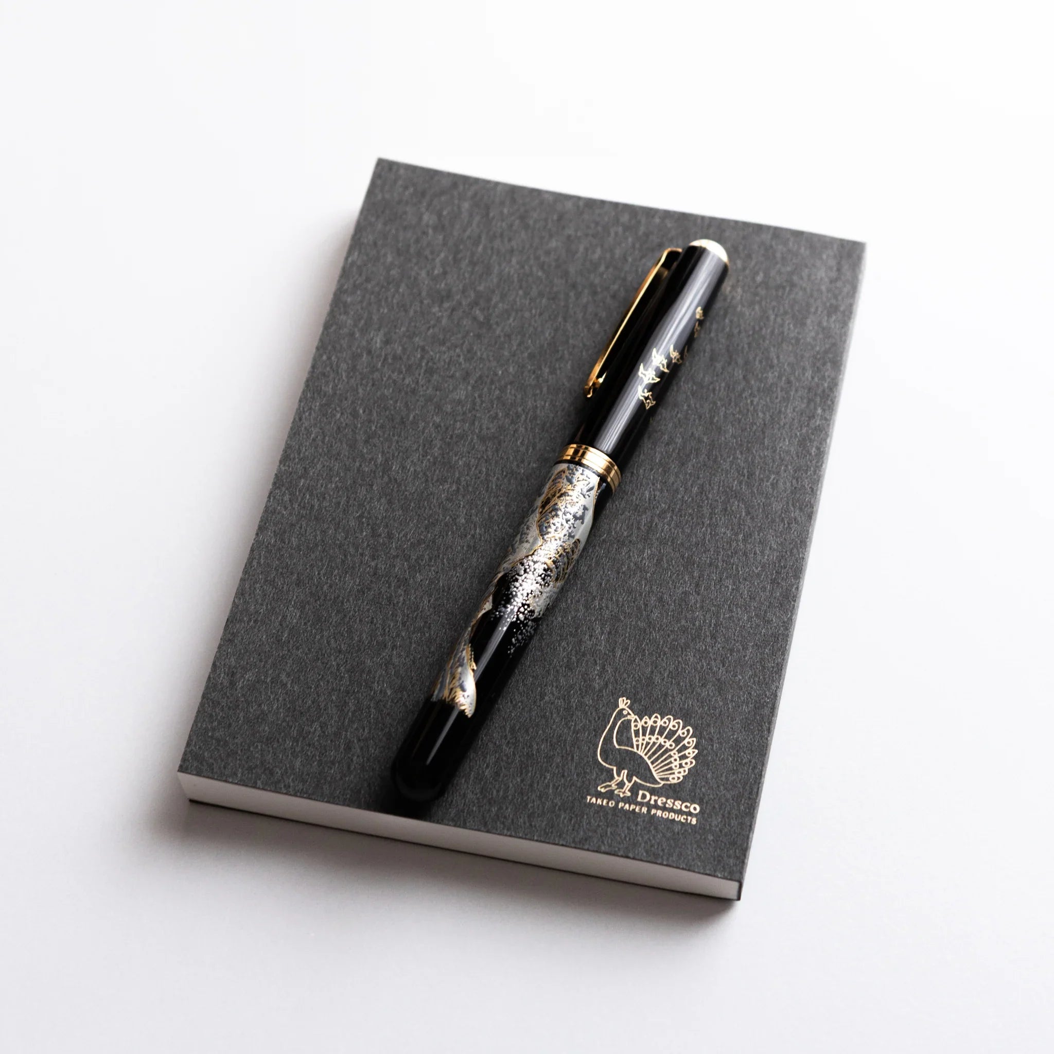 Black and gold Japanese Fountain Pen placed on Dressco Black Onion Skin Japanese Notebook A6.