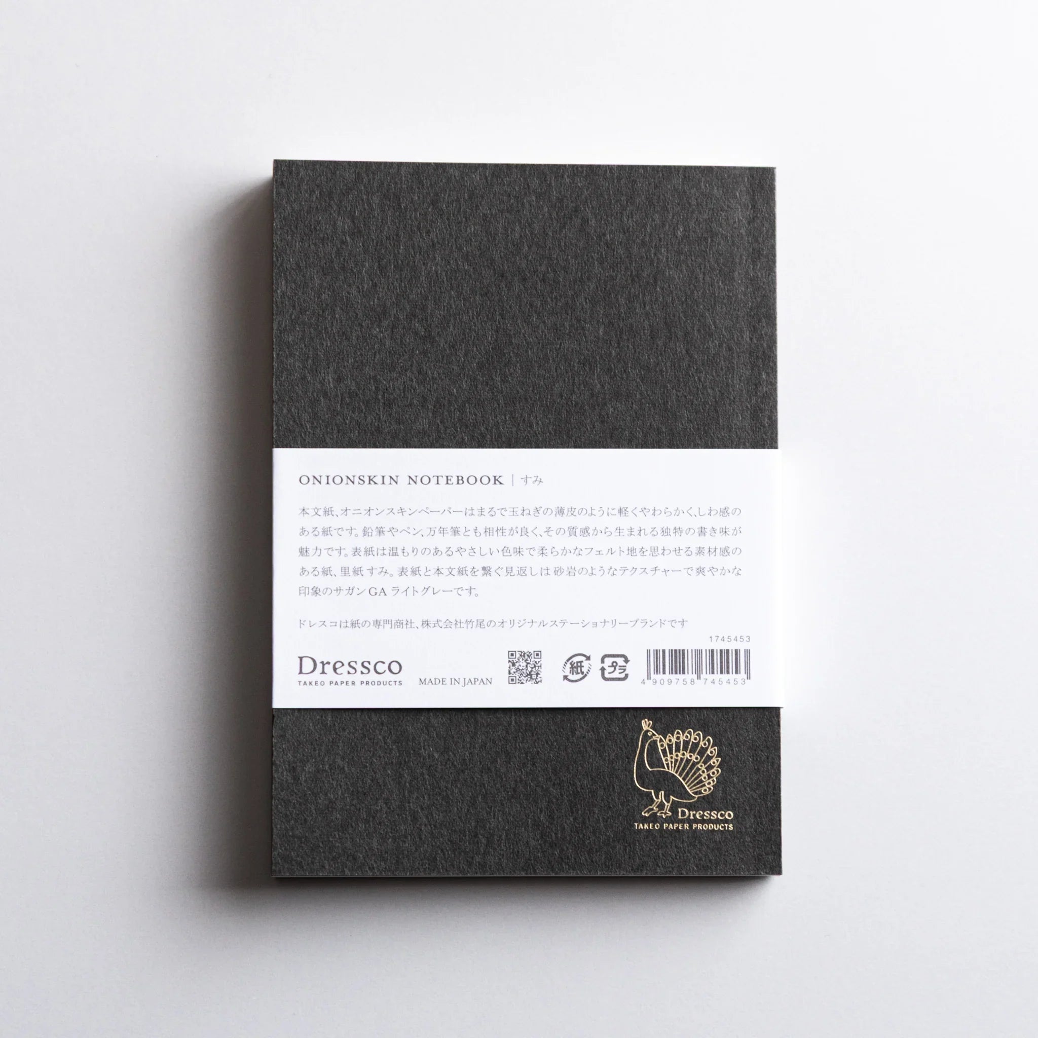 Back view of Dressco Gray Onion Skin Japanese Notebook A6 with white label and gold peacock logo on textured cover.