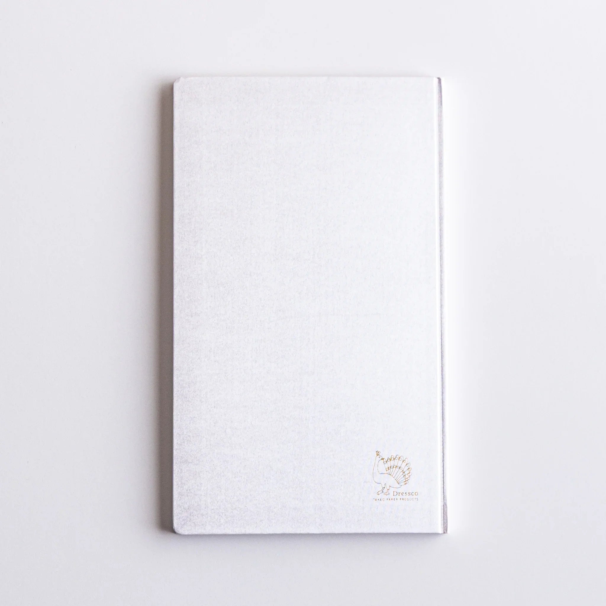 Gold Dressco peacock logo embossed on Platinum cover of Japanese Notebook.