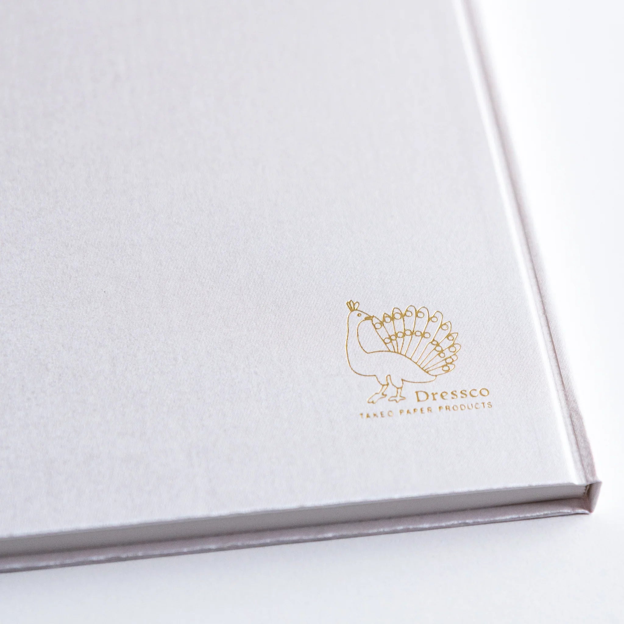 Gold Dressco peacock logo embossed on Platinum cover of Japanese Notebook.