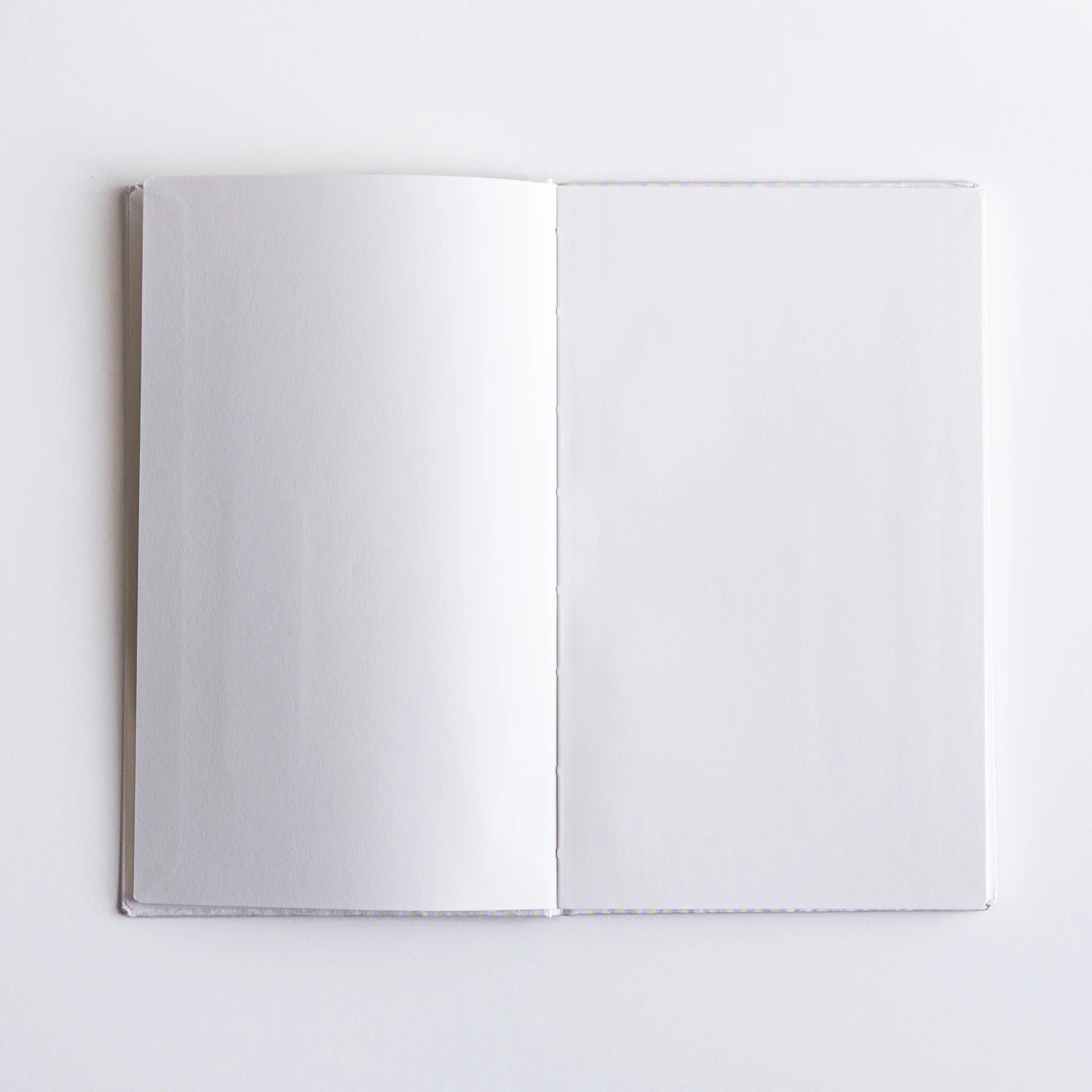 Open pages of Dressco Spica Laid Bond Japanese Notebook B6 showing fine white paper texture.