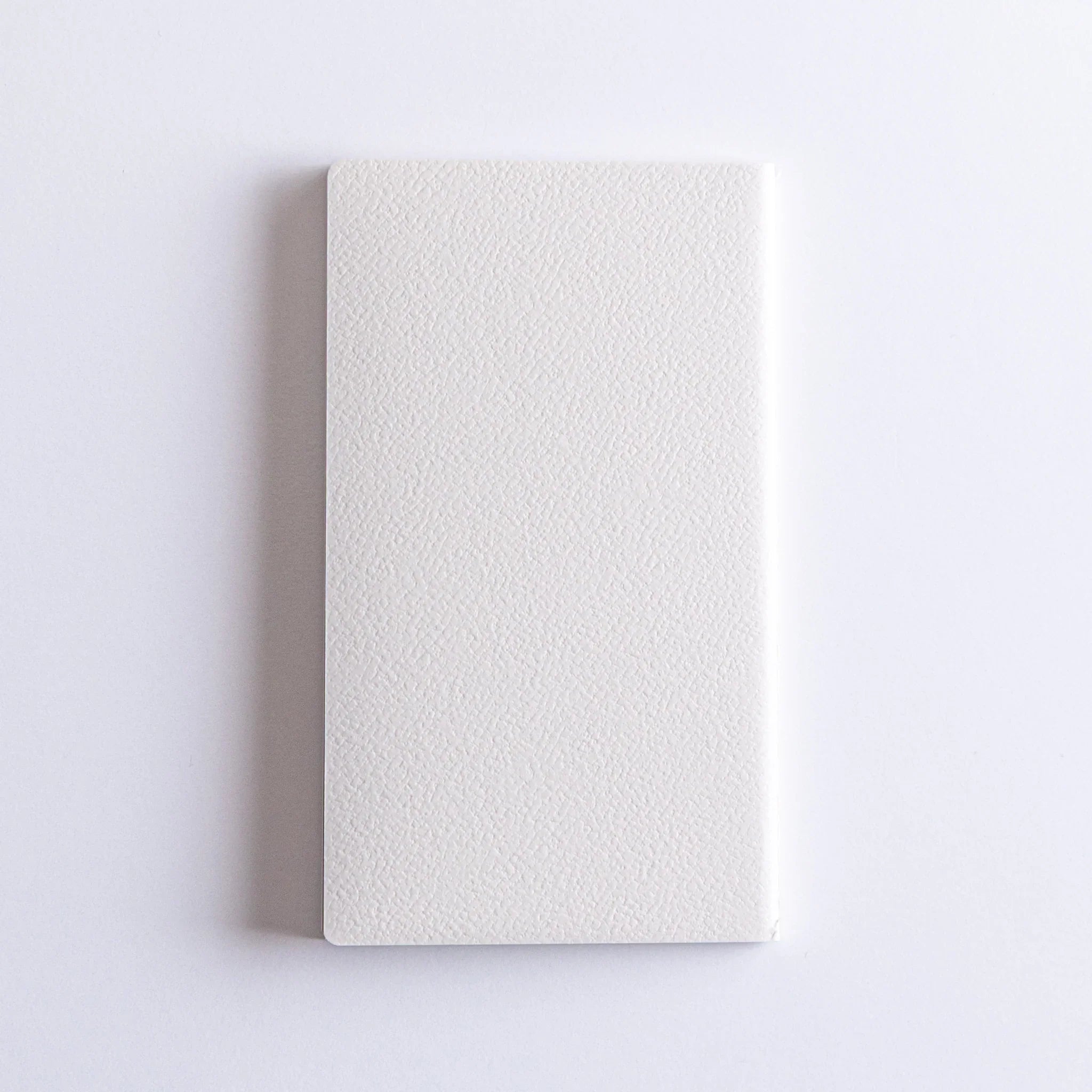 Closed Dressco Spica Laid Bond Japanese Notebook, White textured cover.