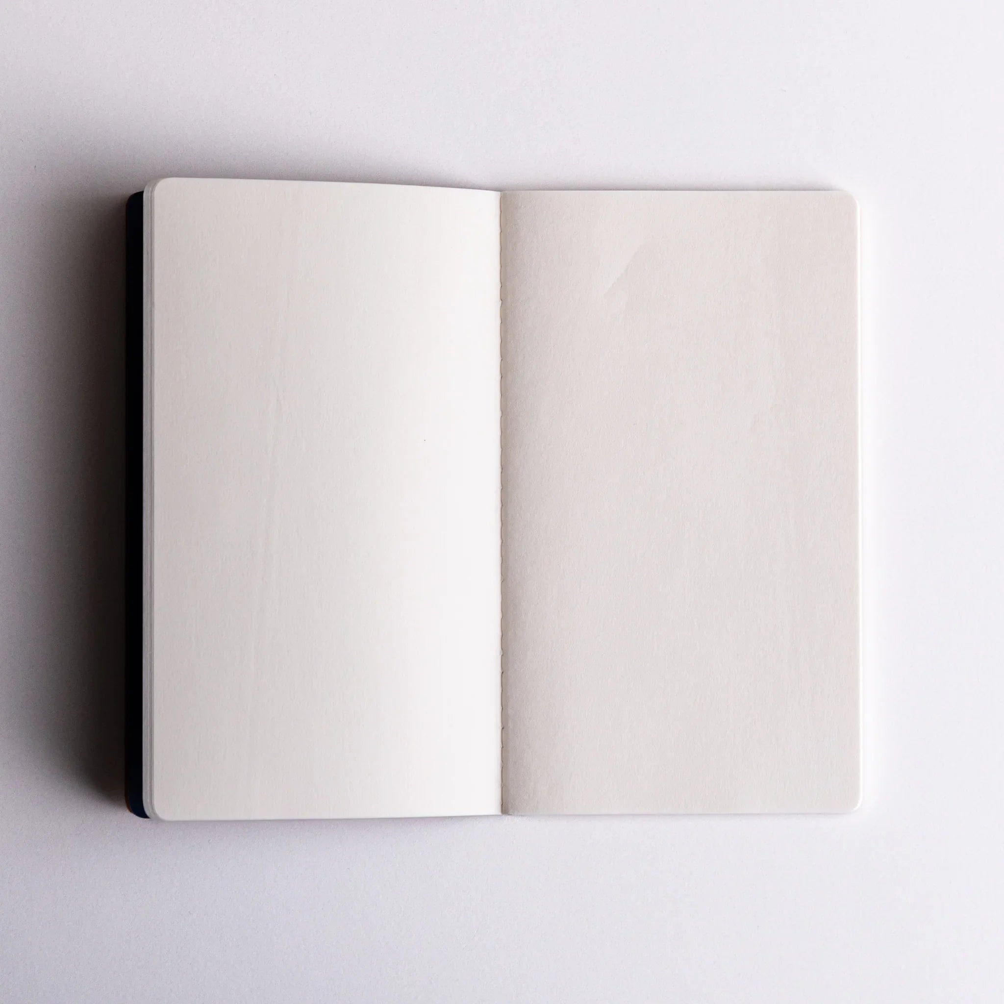 Open Japanese notebook made from Bank Ledger Paper showing blank white pages.
