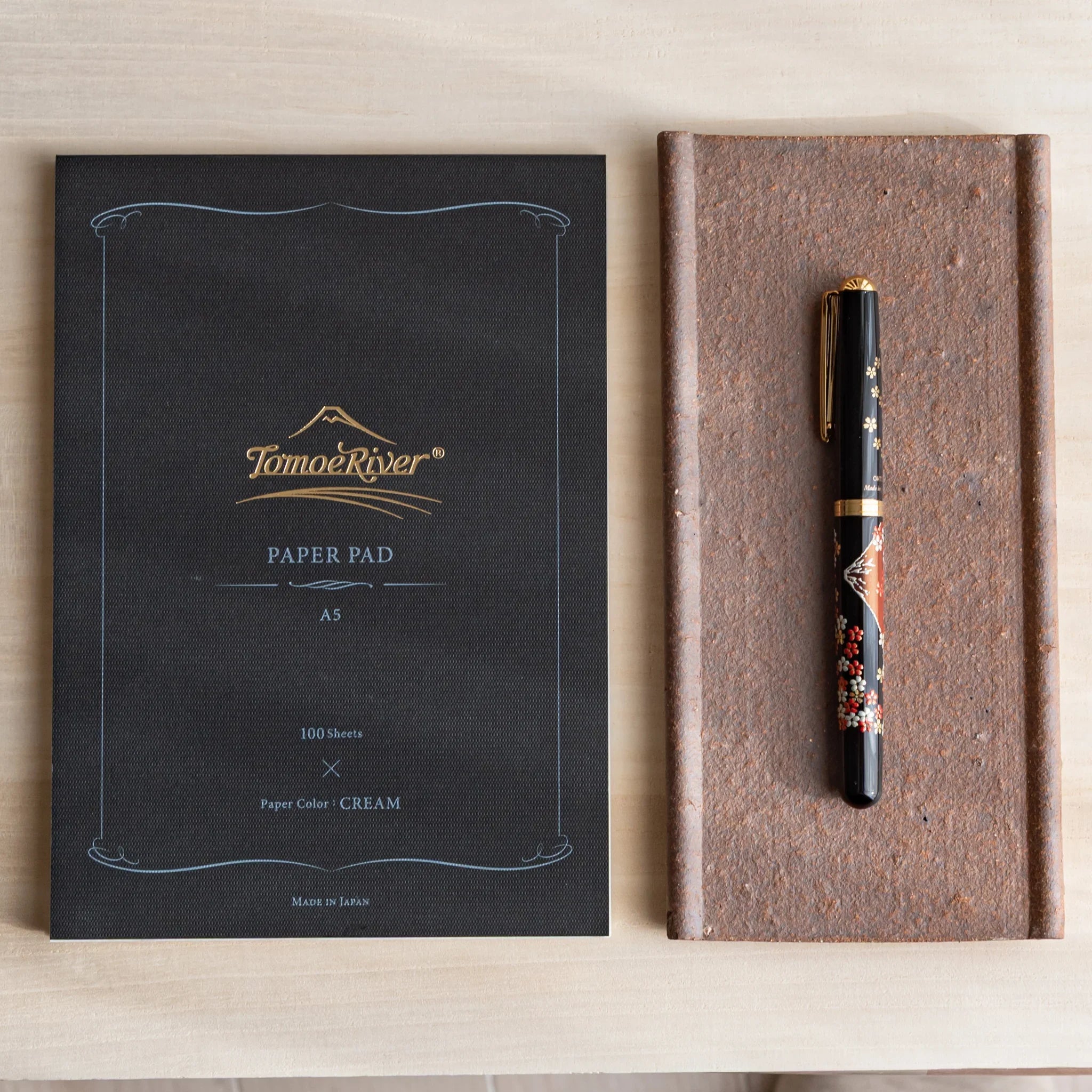 Japanese Pen Tray Desk Accessory with yakishime clay ceramic tray beside a Tomoe River paper pad, holding a fountain pen.