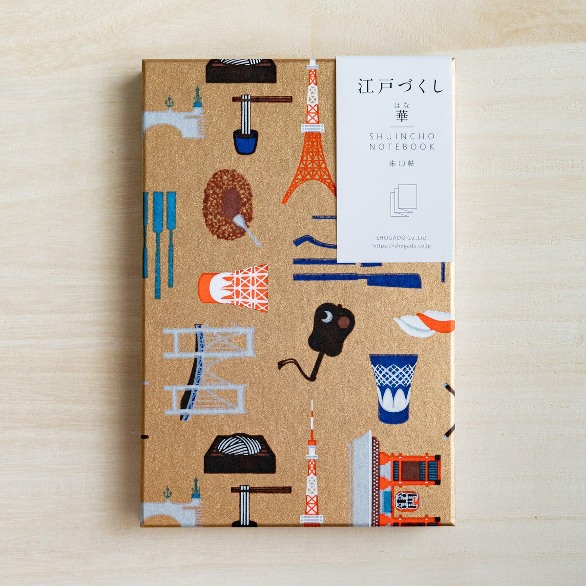 Edo Tokyo goshuincho stamp book, gold washi cover with Tokyo Tower and city motifs, white paper belly band