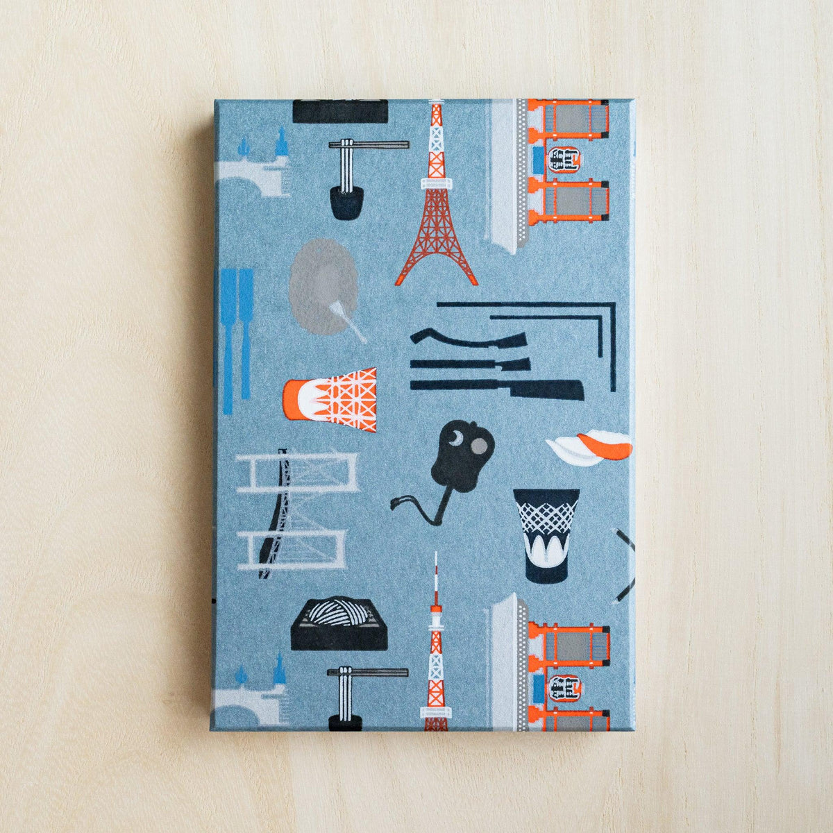 Full slate blue cover of Edo Tokyo goshuincho stamp book with Tokyo Tower, Skytree, bridge and sushi motifs