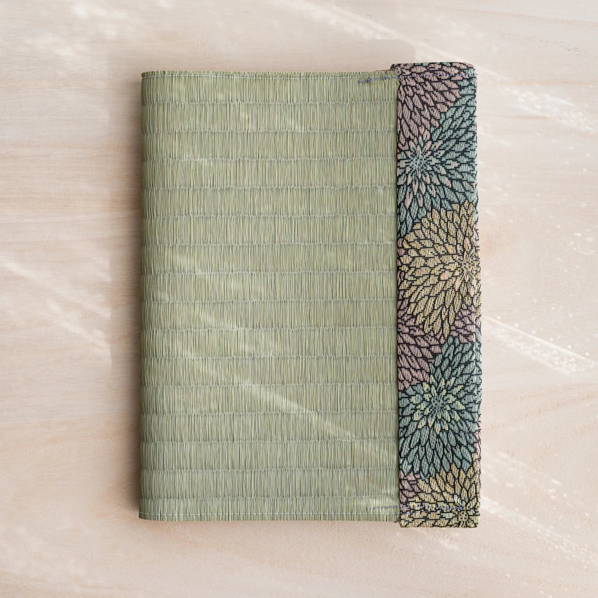 Elegant Chrysanthemum tatami book cover closed, green rush straw with green pink and yellow Japanese chrysanthemum band