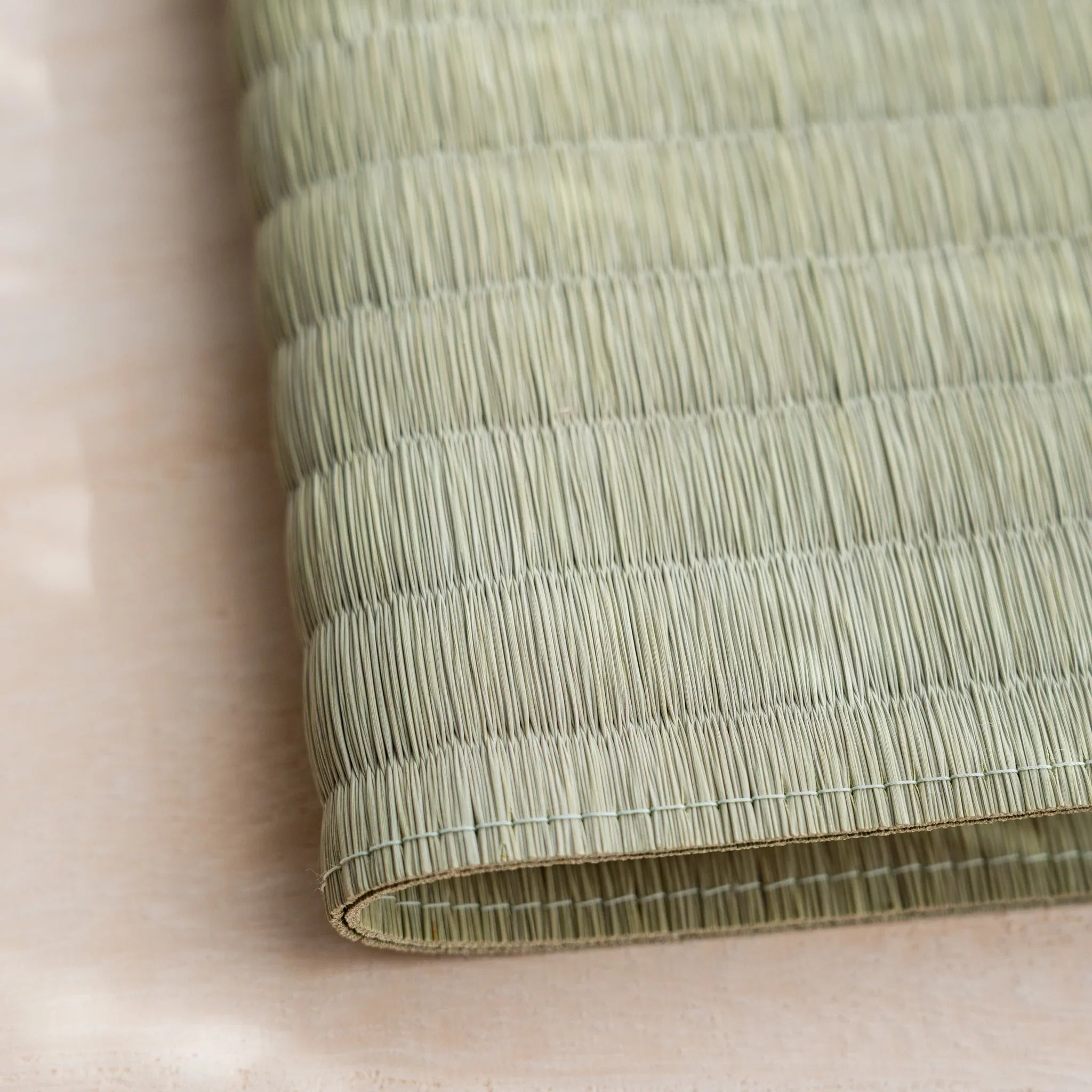 Close-up of the woven green rush straw surface and folded edge of the Elegant Chrysanthemum tatami book cover