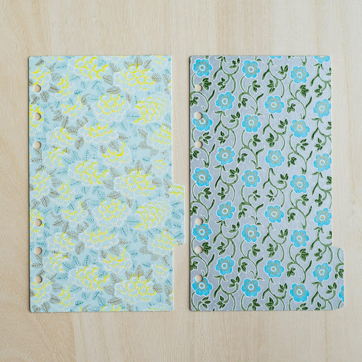 Two Garden index dividers side by side, pale blue with yellow chrysanthemums and grey with turquoise flowers