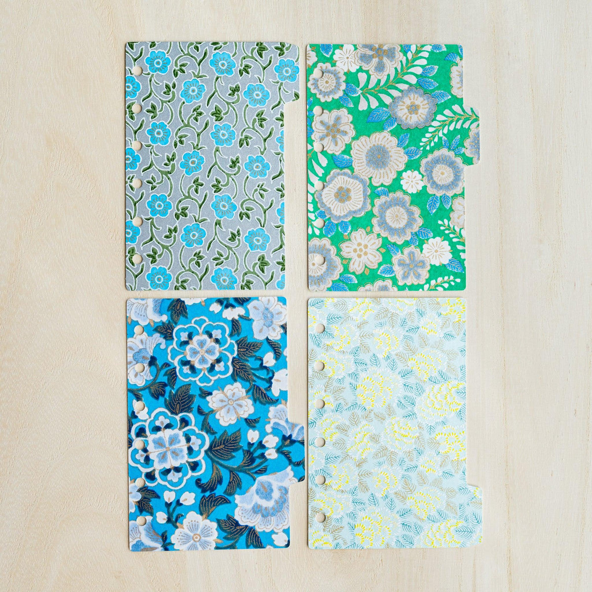 Four Garden Mini 6 index dividers laid in a grid, grey vine, green floral, bright blue and pale yellow prints