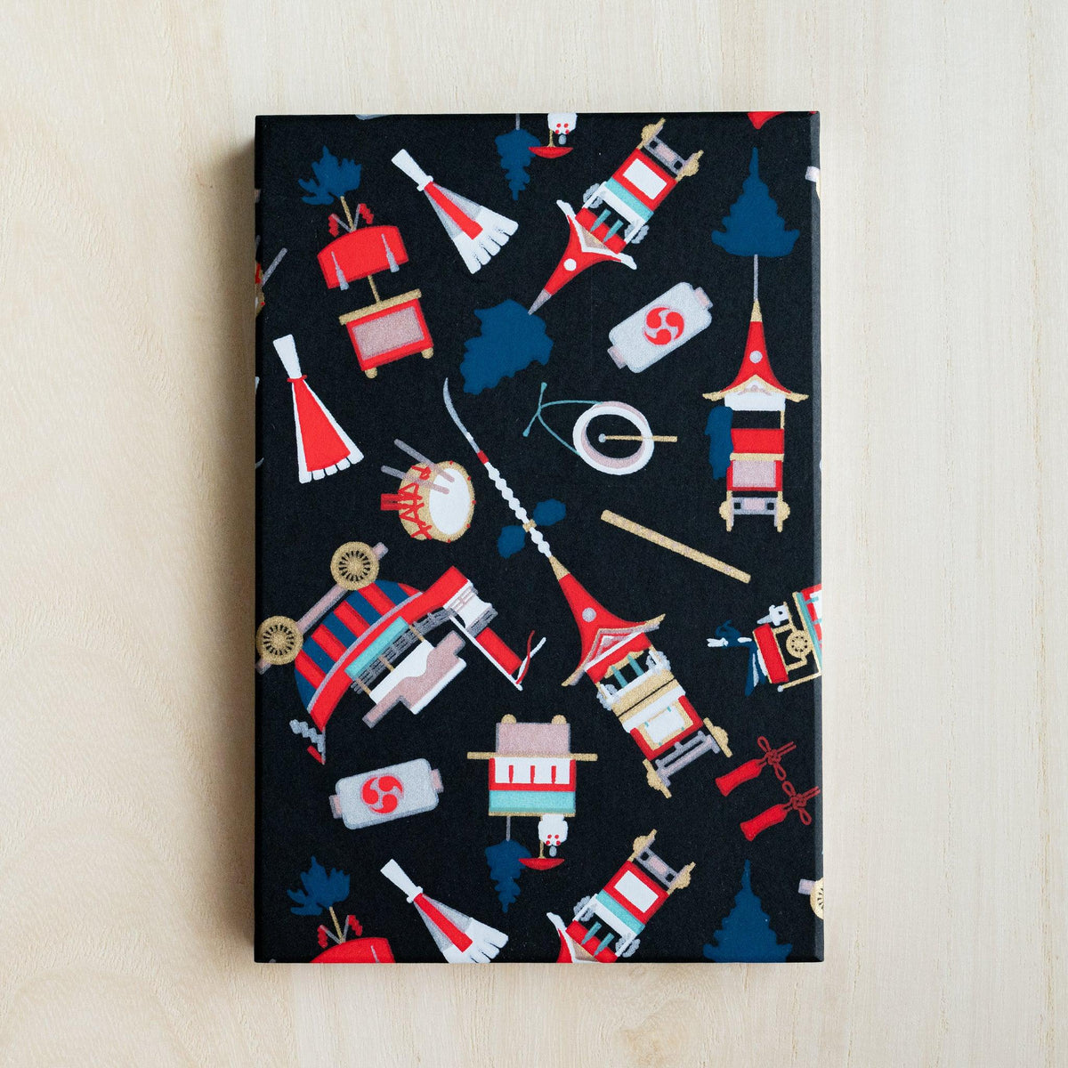 Full black cover of Gion Kyoto goshuincho stamp book with red, white, blue and gold festival float motifs