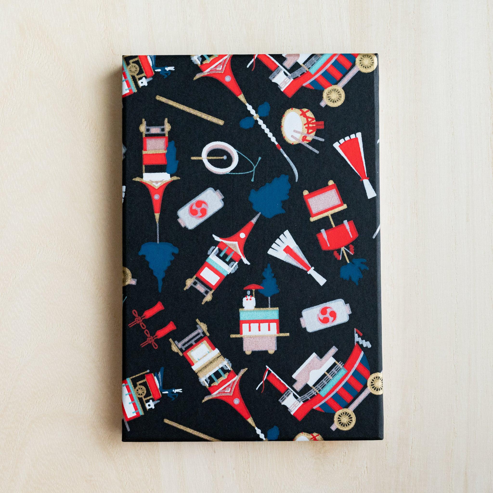 Gion Kyoto goshuincho stamp book cover in black washi with red floats, taiko drums, lanterns and pine trees