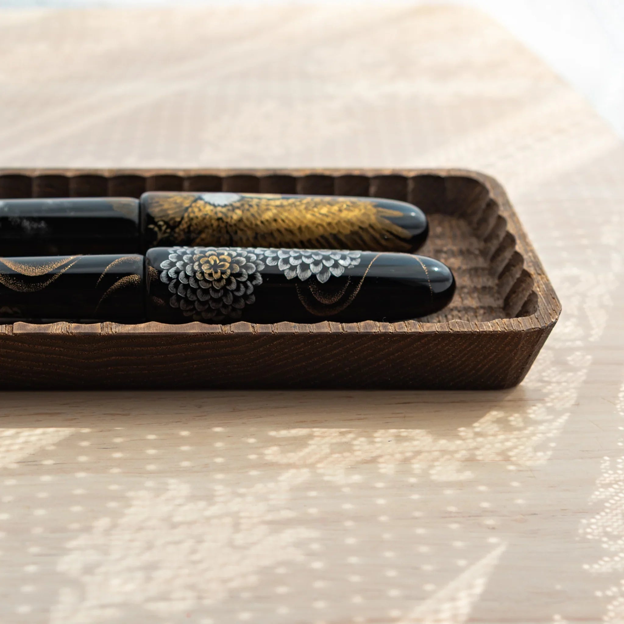 Side view of the carved Japanese Pen Tray – Parallel Groove Edition, showing detailed edge work and wood texture.