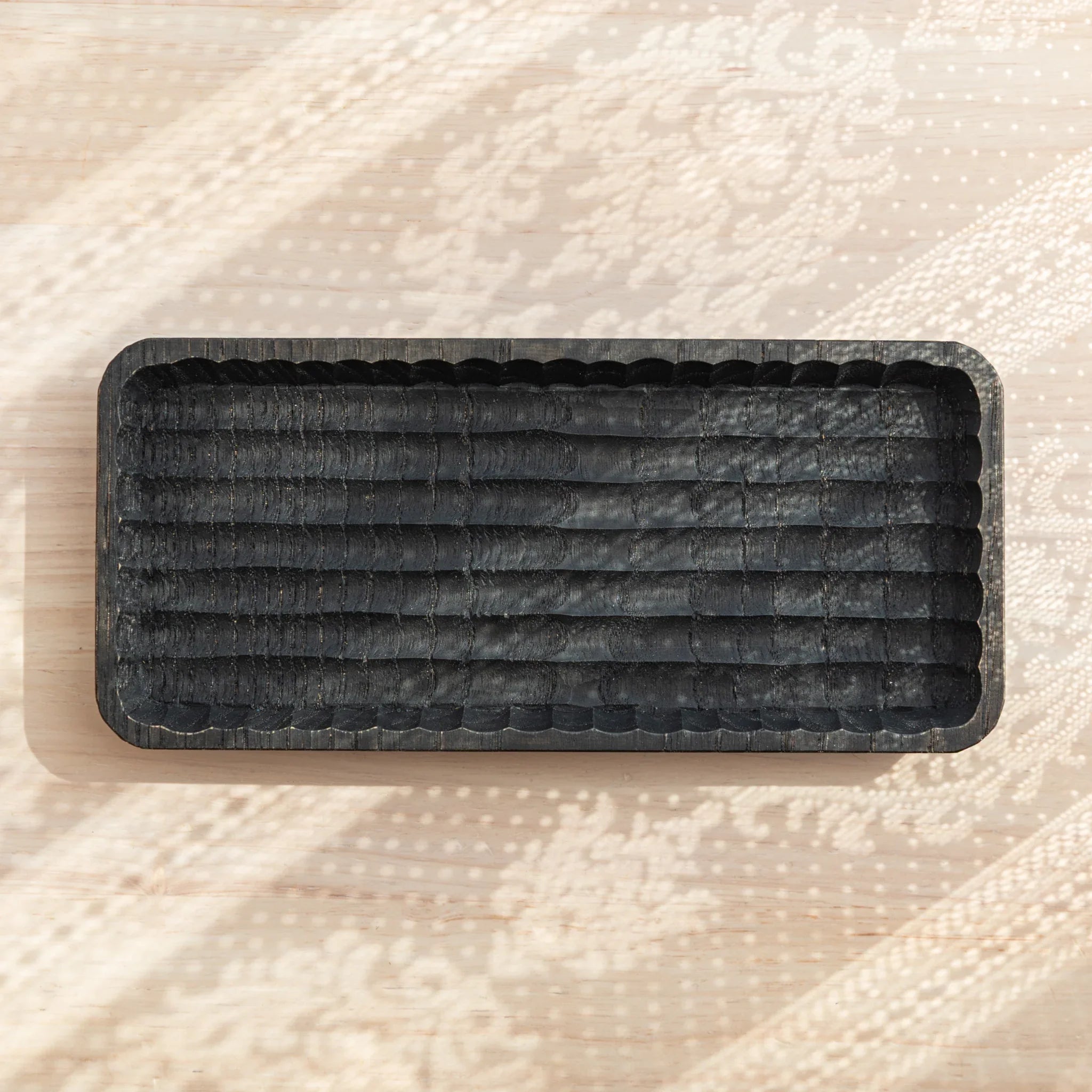 Top view of the Hand-Carved Japanese Pen Tray with parallel grooves in black wood.