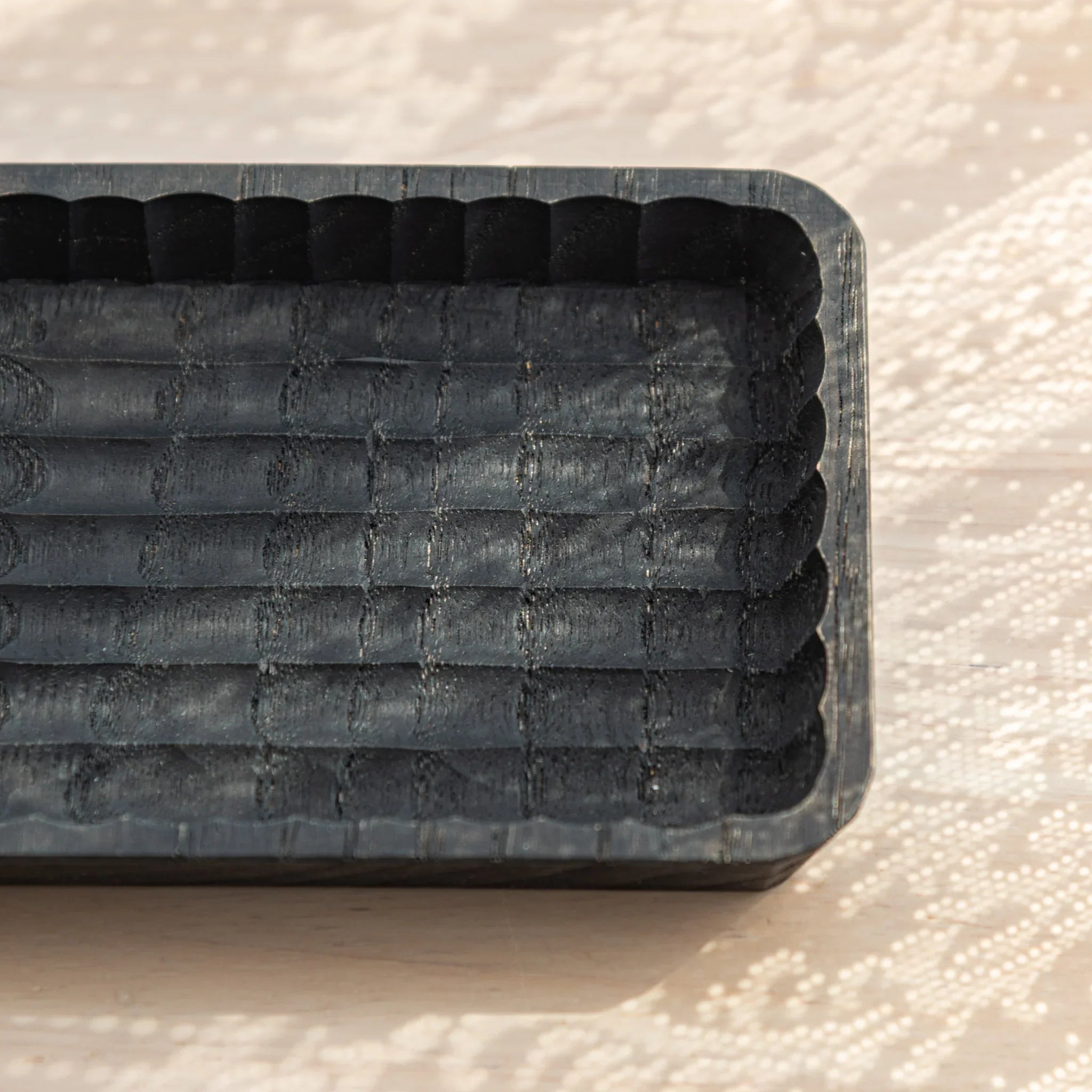 Close-up of the corner details of the black hand-carved Japanese Pen Tray.