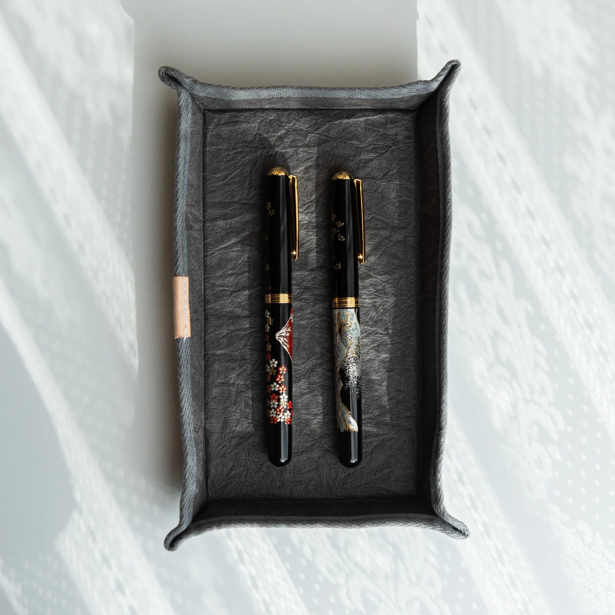 Japanese Pen Tray – Grey holding two lacquered Japanese Fountain Pens, combining refined craft and elegant functionality.