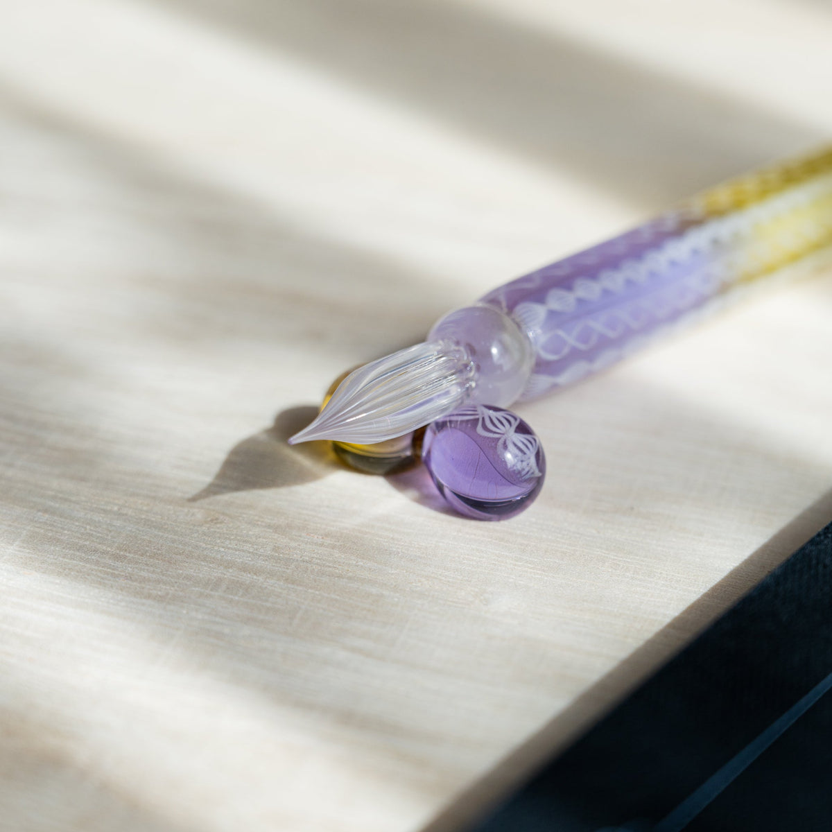 Helix Wisteria glass dip pen nib and lavender sphere pen rest, showing the ribbed clear glass tip