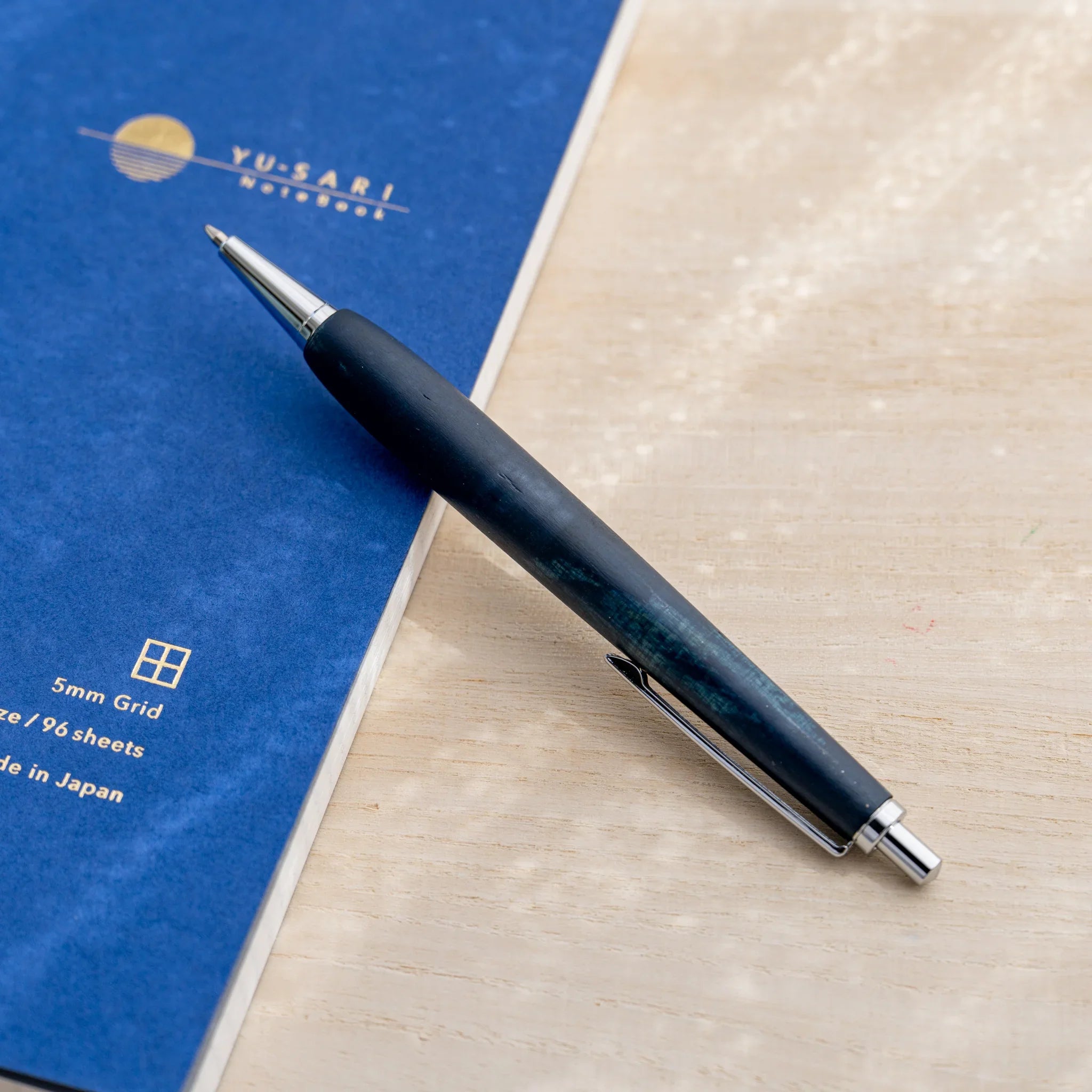Horse chestnut wood urushi lacquered ballpoint pen in indigo blue, Japanese wood, full-body view