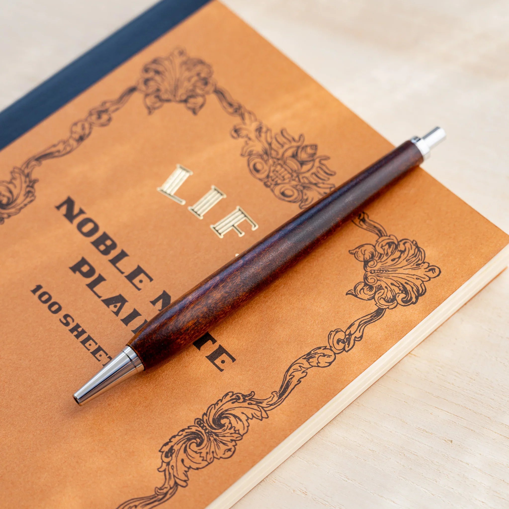 Horse chestnut wood urushi lacquered ballpoint pen in amber-brown, Japanese wood, full-body view