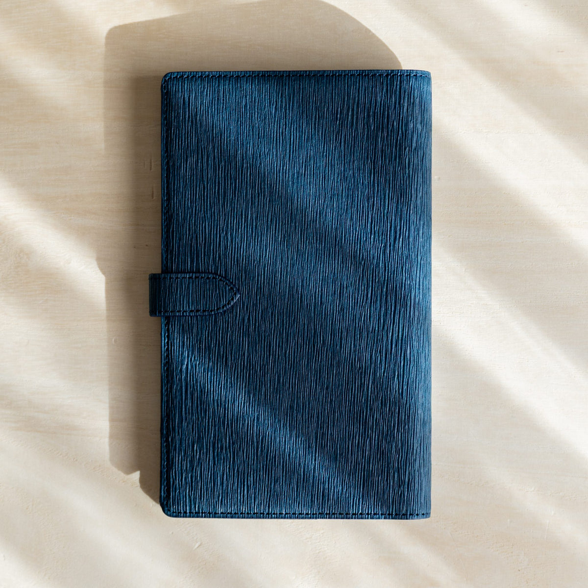 Navy Ise Gikakushi paper leather planner, back cover with crease texture and strap tab