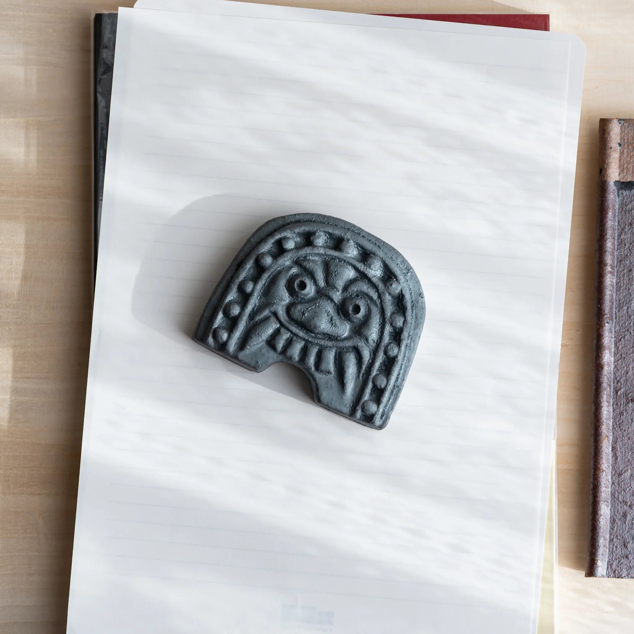 Japanese Paperweight inspired by Oni-gawara roof tiles, ceramic piece with a calm gray tone as a refined Desk Accessory.