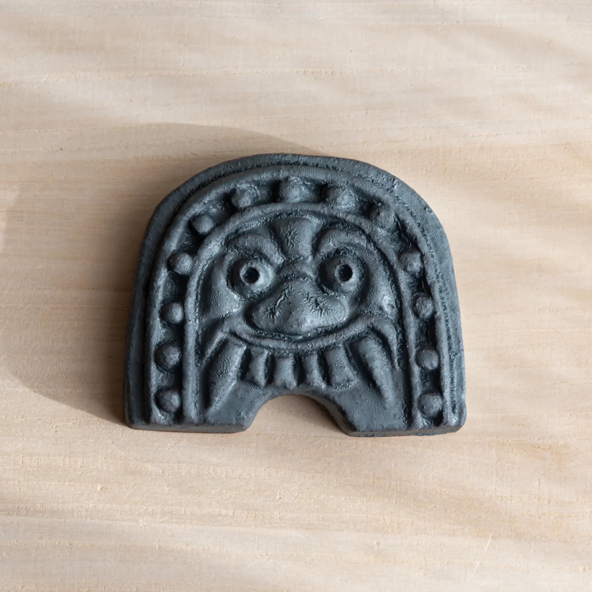 Japanese Kawara Roof Guardian Paperweight with a rounded face, handcrafted gray ceramic piece symbolizing calm protection.