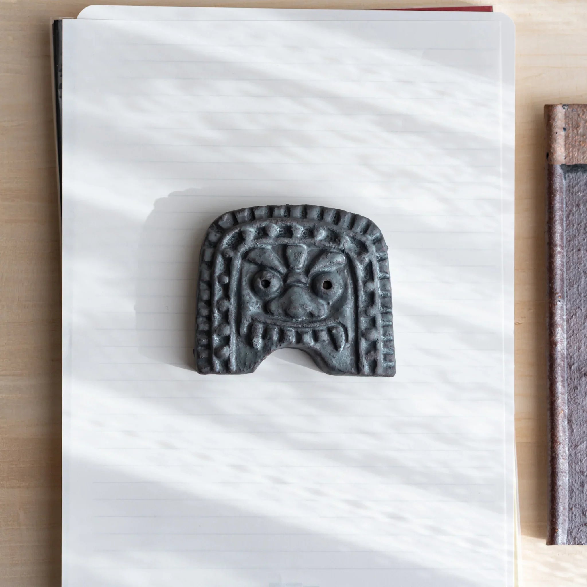 Japanese Paperweight inspired by Oni-gawara roof tiles, ceramic piece with a calm gray tone as a refined Desk Accessory.