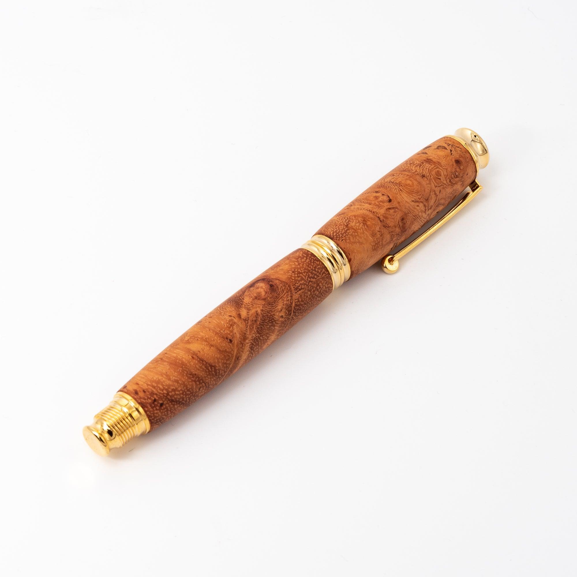 A Japanese fountain pen featuring a Karin wood barrel and gold screw cap, shown horizontally against a plain white background for a clean presentation.