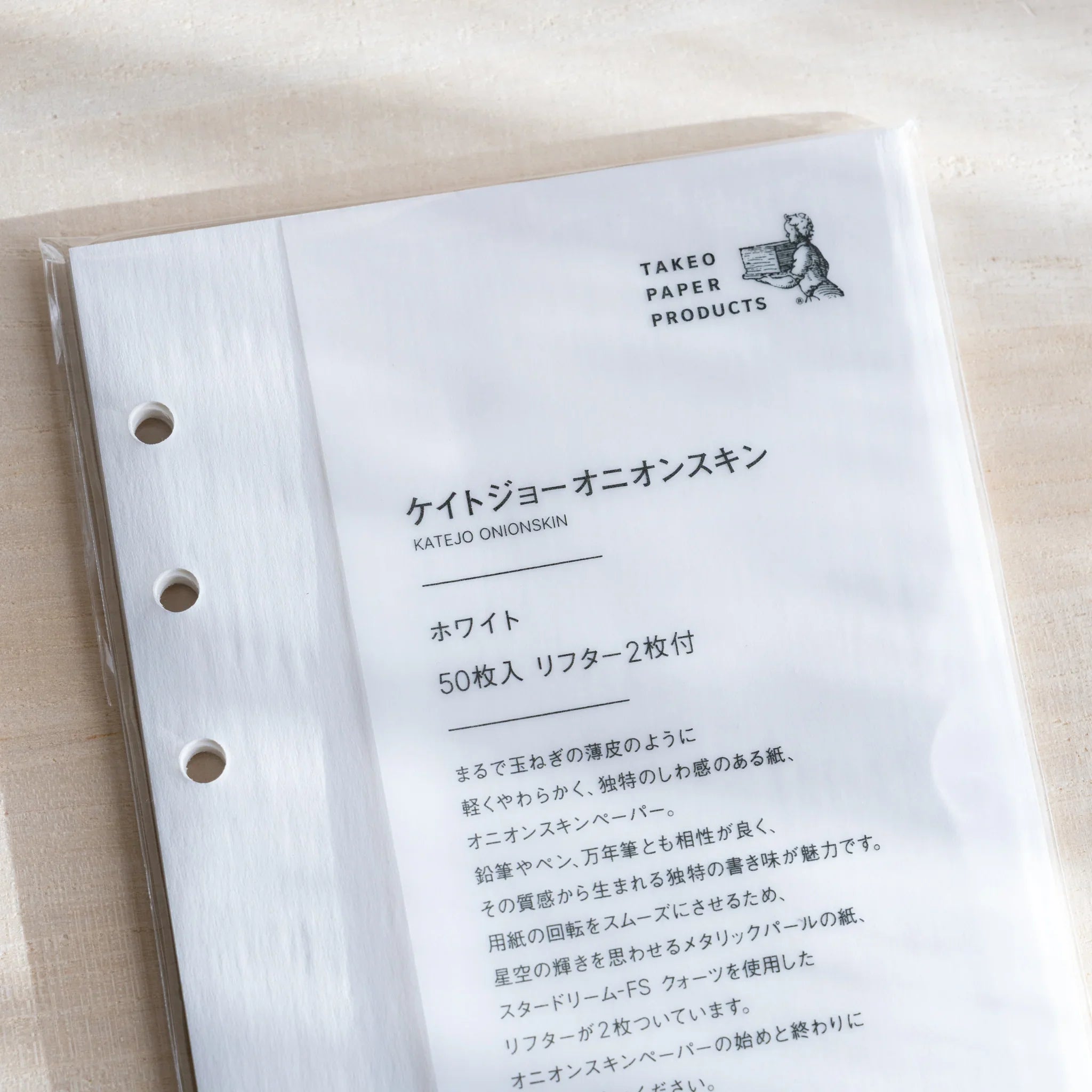 Close-up of Japanese Stationery onion skin planner refill in clear packaging, showing details and six-hole punches.