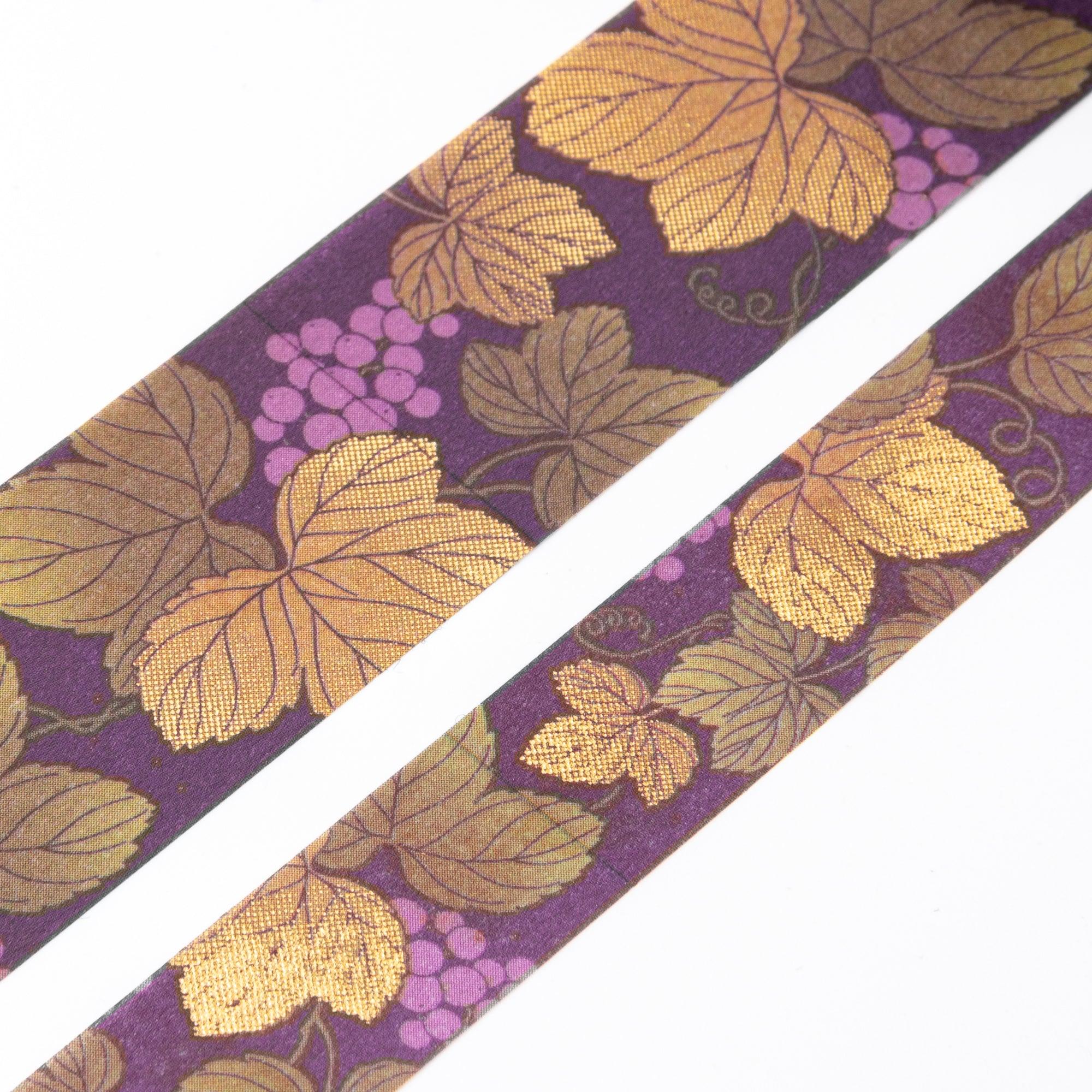 Close-up of Iyo Washi Tape showcasing intricate grape designs with vibrant colors, emphasizing its artistic craftsmanship on a desk.  