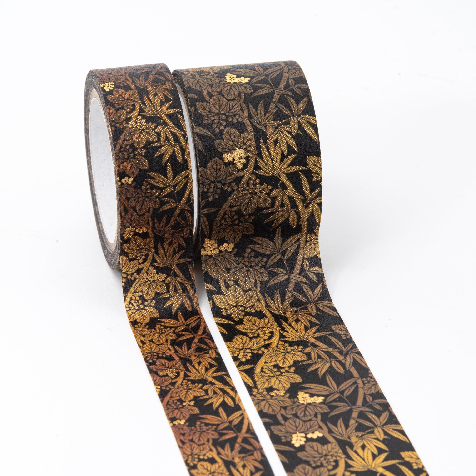 Two black washi tape rolls with elegant gold and bronze bamboo leaf patterns, showcasing traditional Japanese aesthetics.