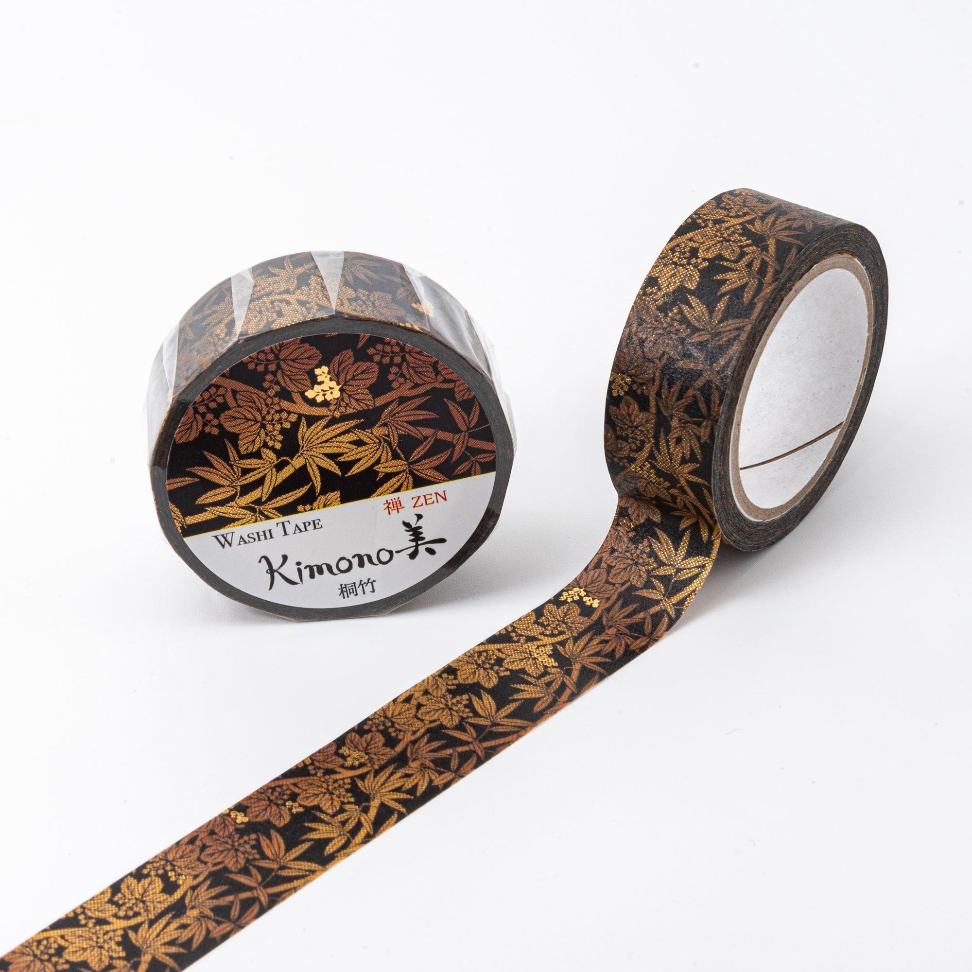 A black washi tape roll with gold bamboo leaf motifs, unrolled to display intricate details and Zen-inspired design.