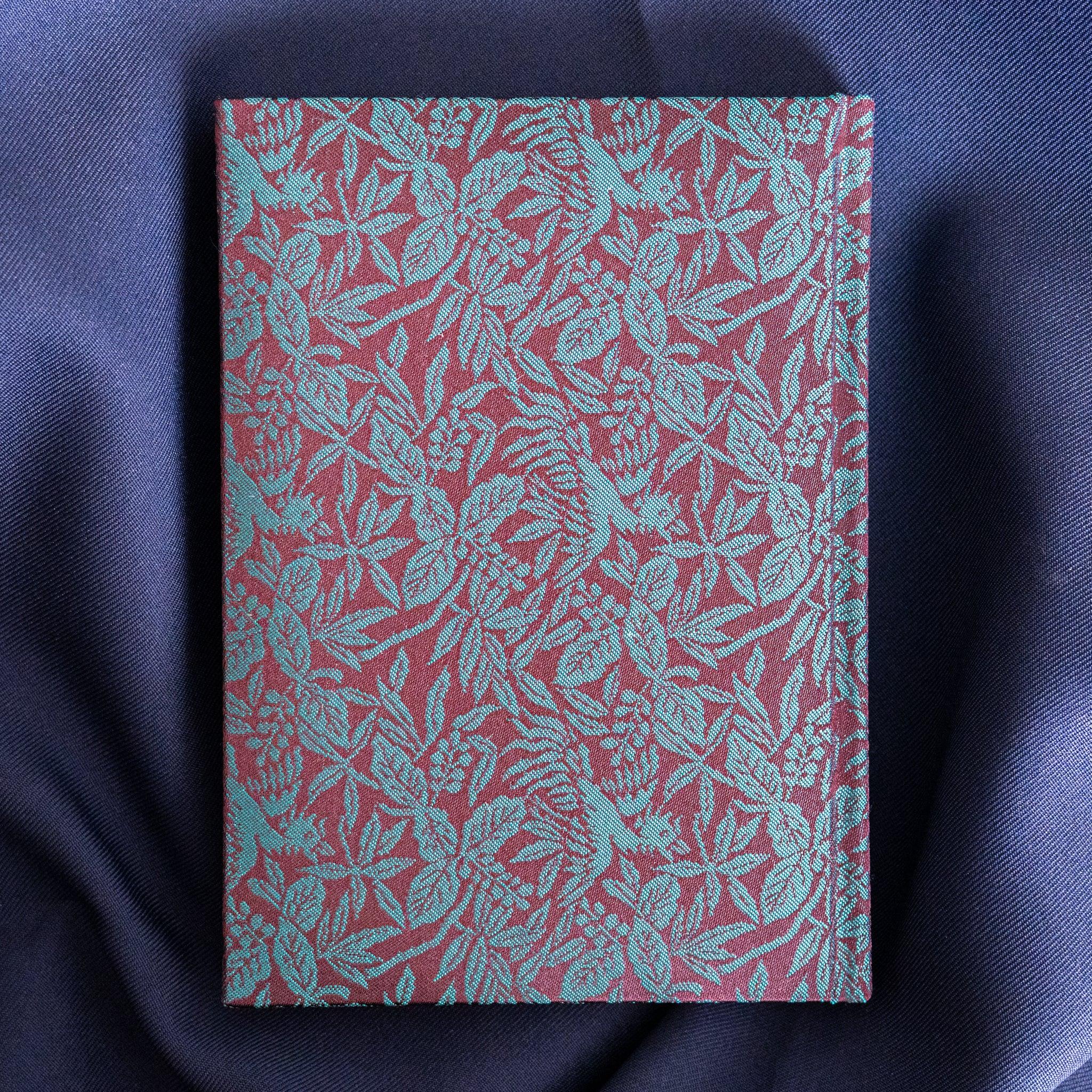 Kiri Take Ho-o Nishijin silk Homeicho notebook straight-on front cover showing full teal leaf pattern on rust red