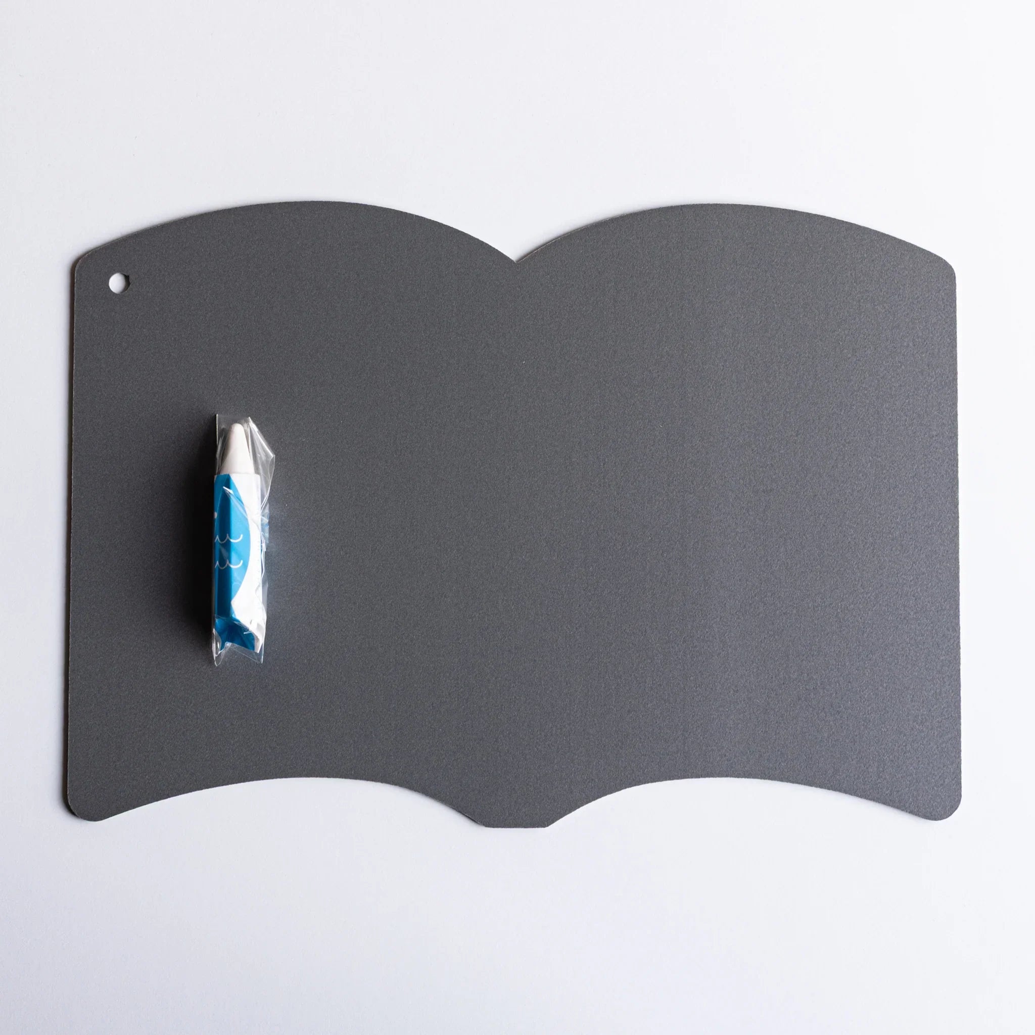 Gray hinged drawing board opened showing interior surface with white crayon and book-shaped design and features