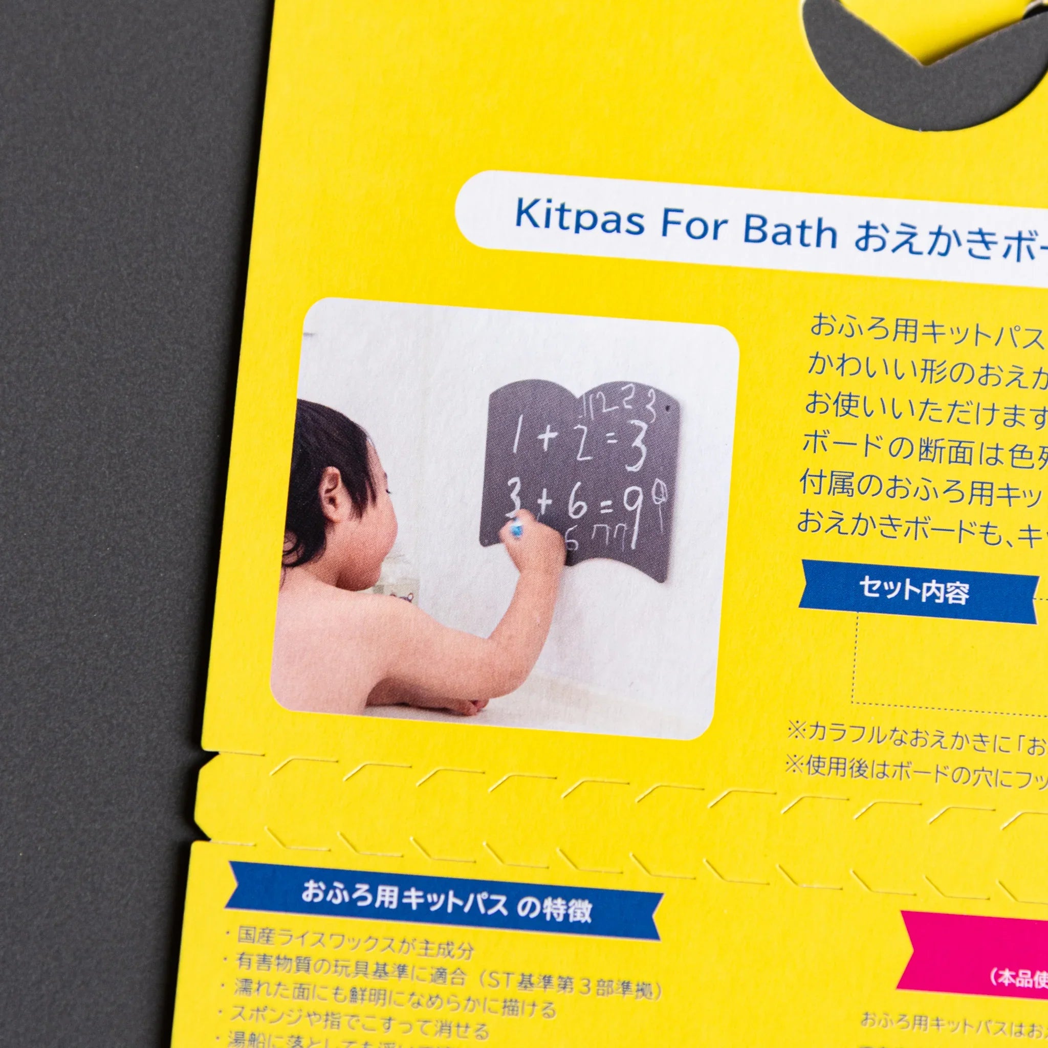 Close-up detail of white button hinge on gray board showing attachment and mechanics and features and features