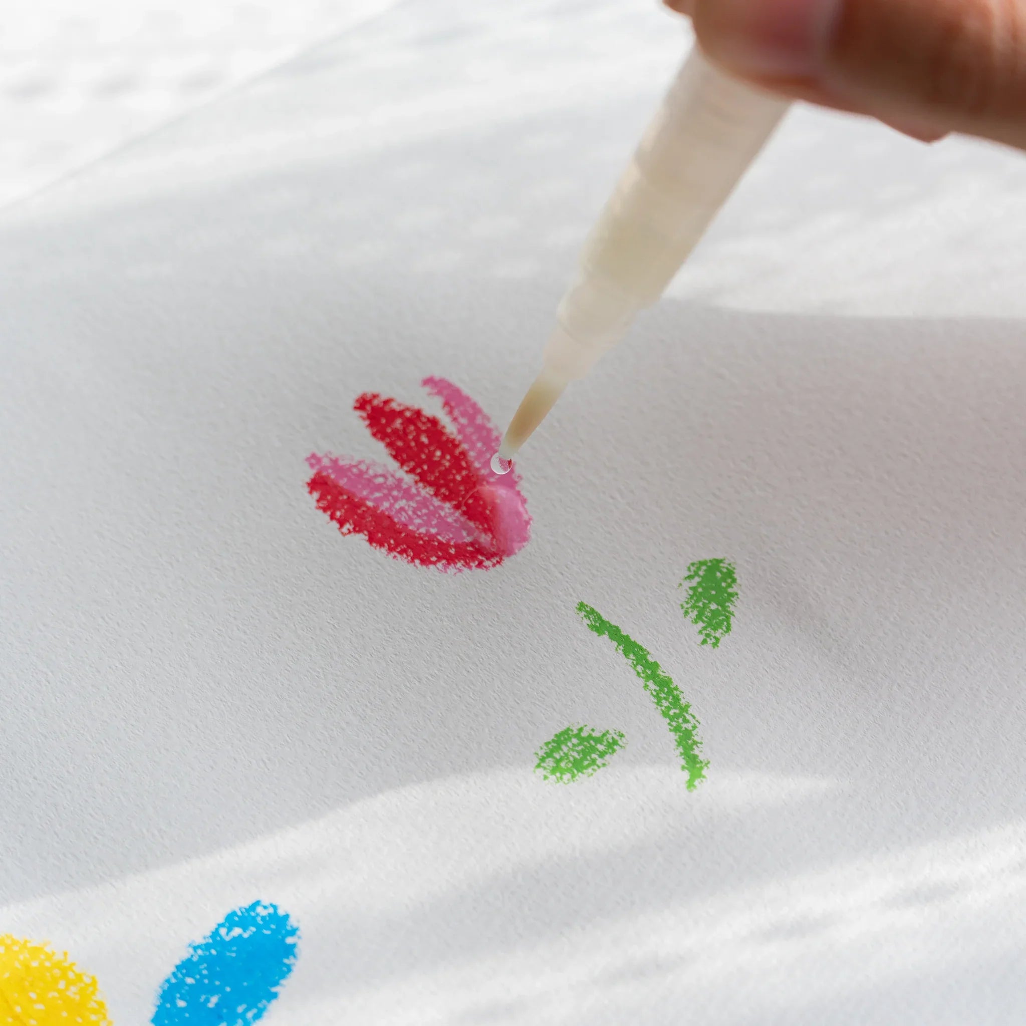 Kitpas Non-Toxic Rice Wax Watercolor Crayons 24-color set arranged artistically with large open box shown