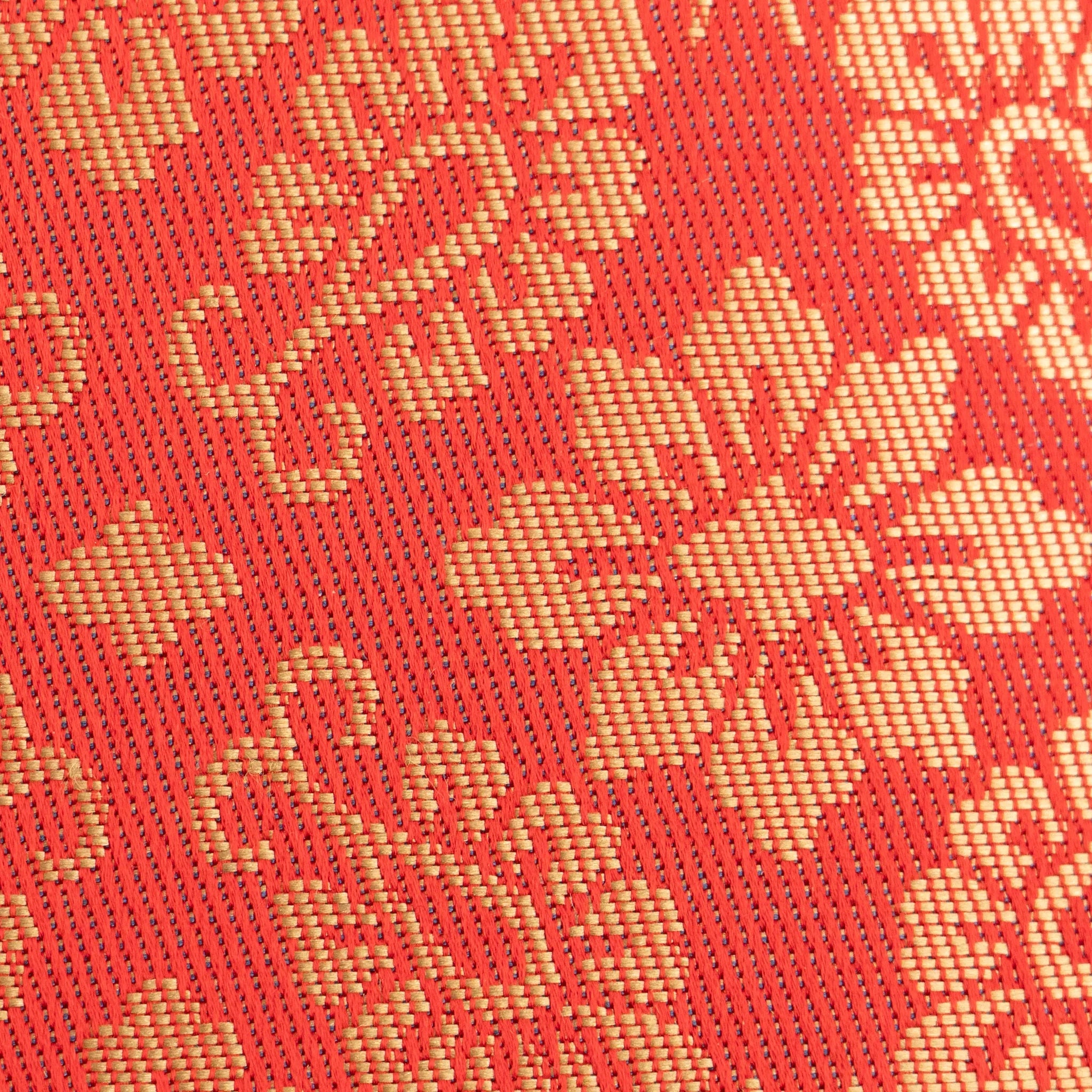 Macro detail of Ko Aoi Nishijin silk weave showing fine thread texture with vermilion background and cream hollyhock motifs