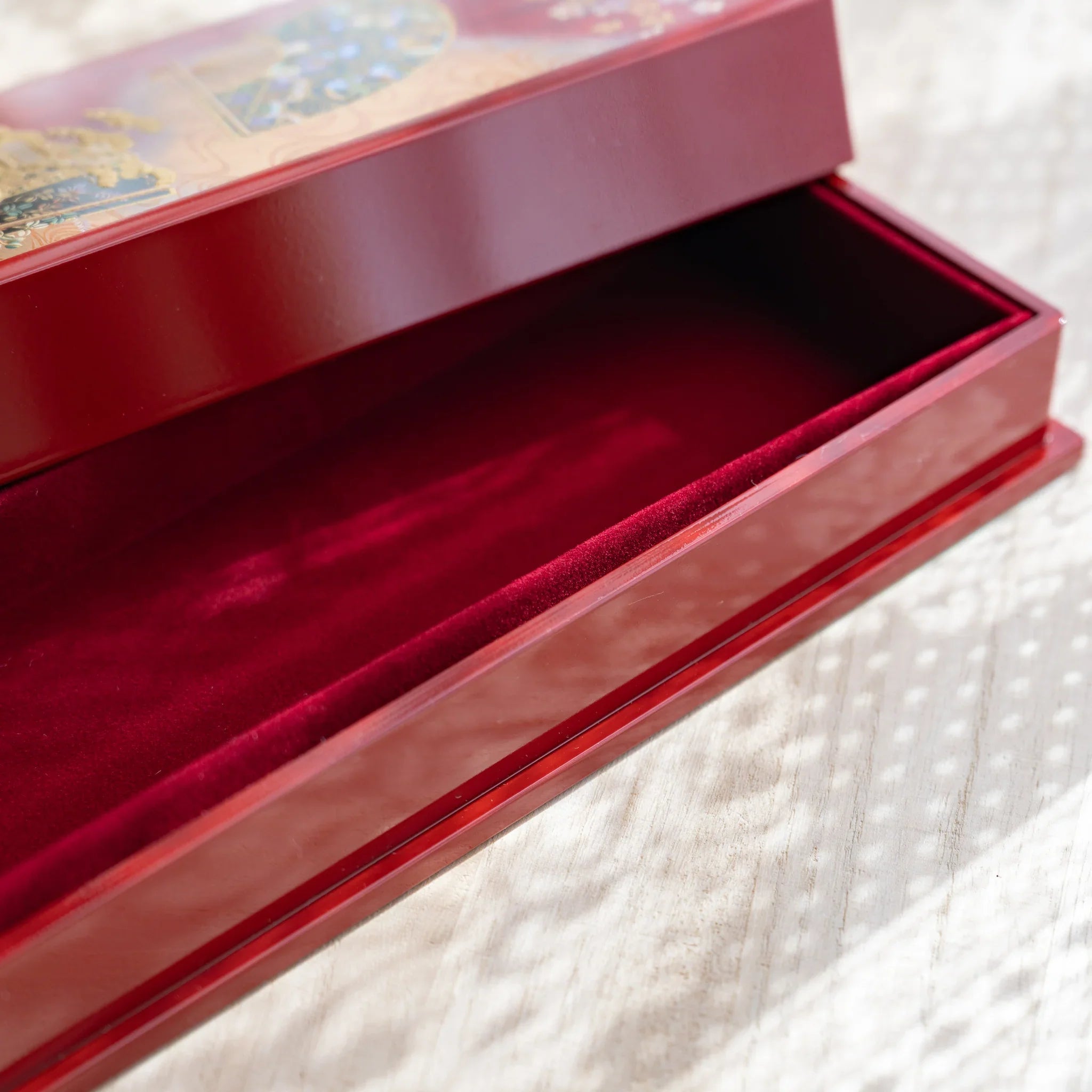 Japanese pen case with lid removed, exposing compartment lined in plush red felt, perfect for multiple pens